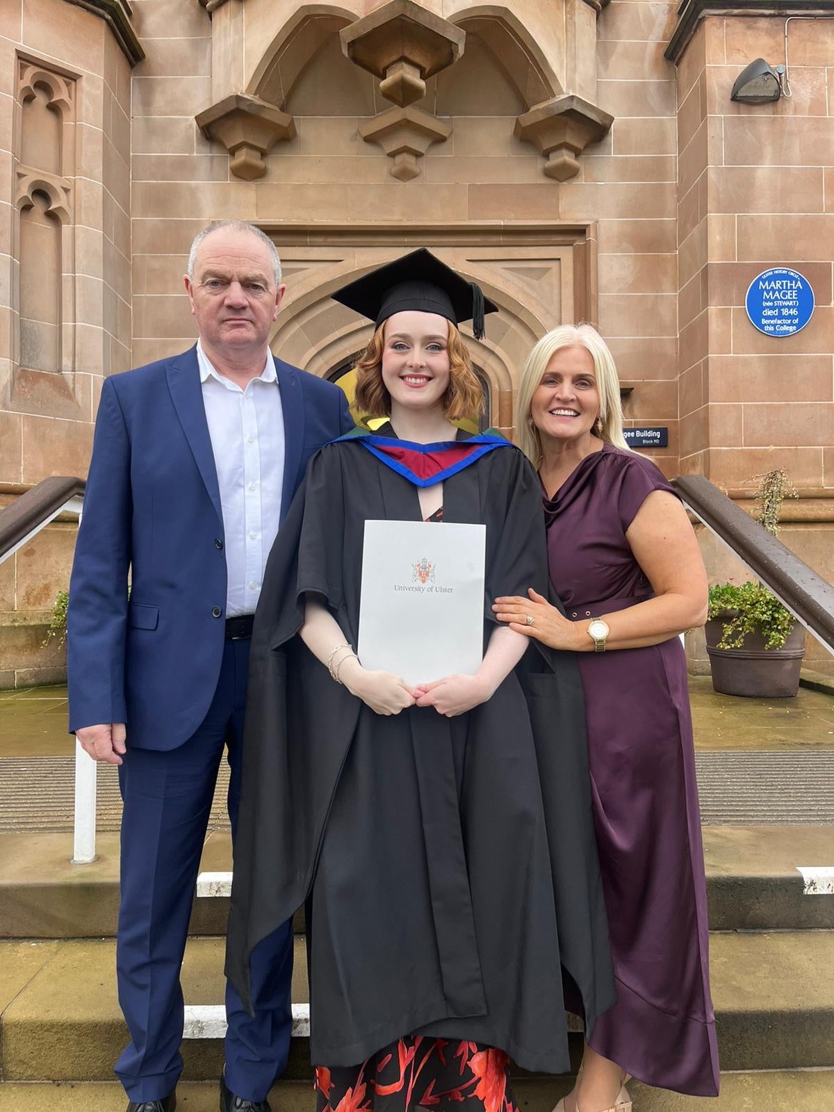 A lady and her family at her graduation