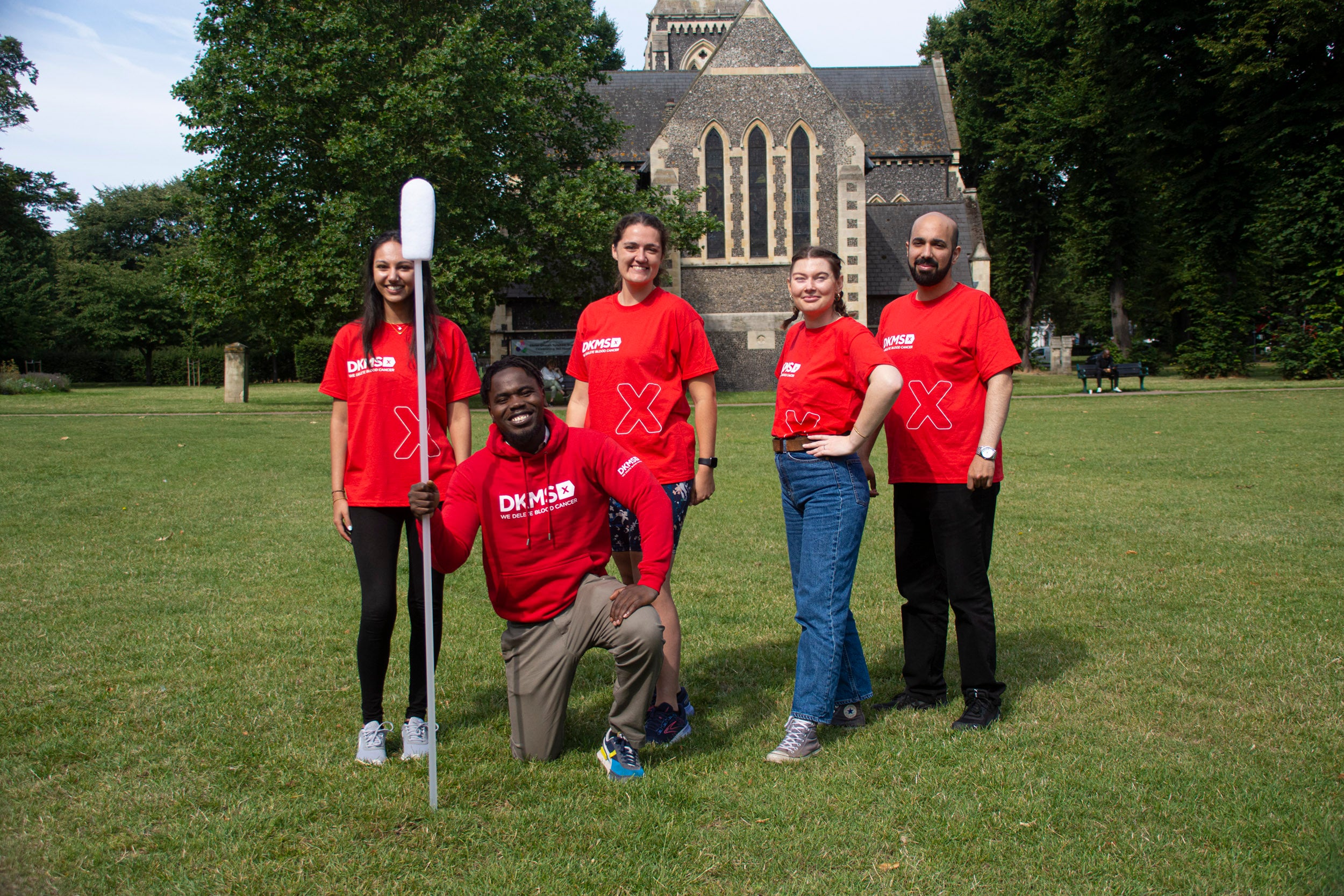 Five DKMS staff with a giant swab