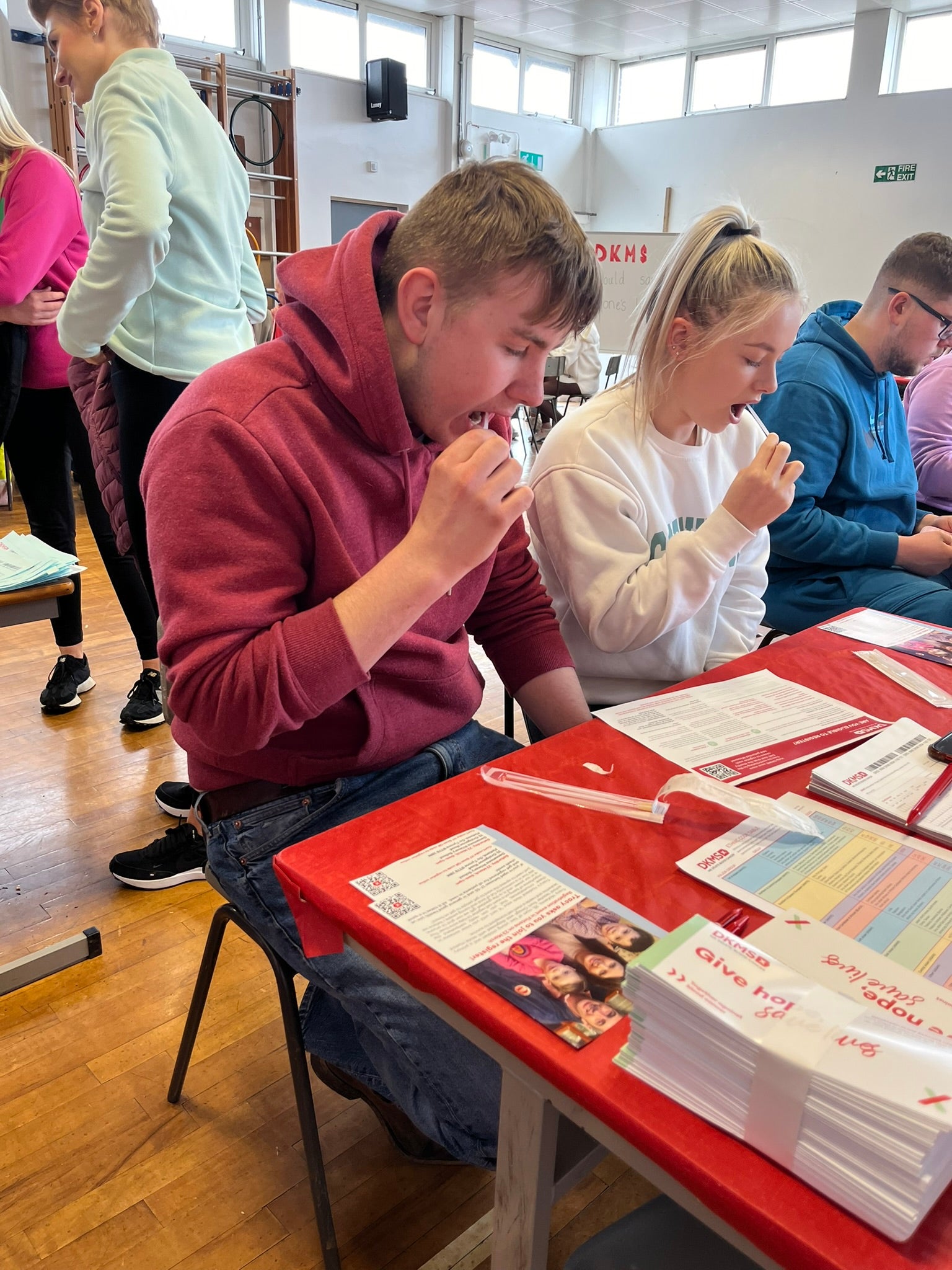 Young man swabbing at DKMS event