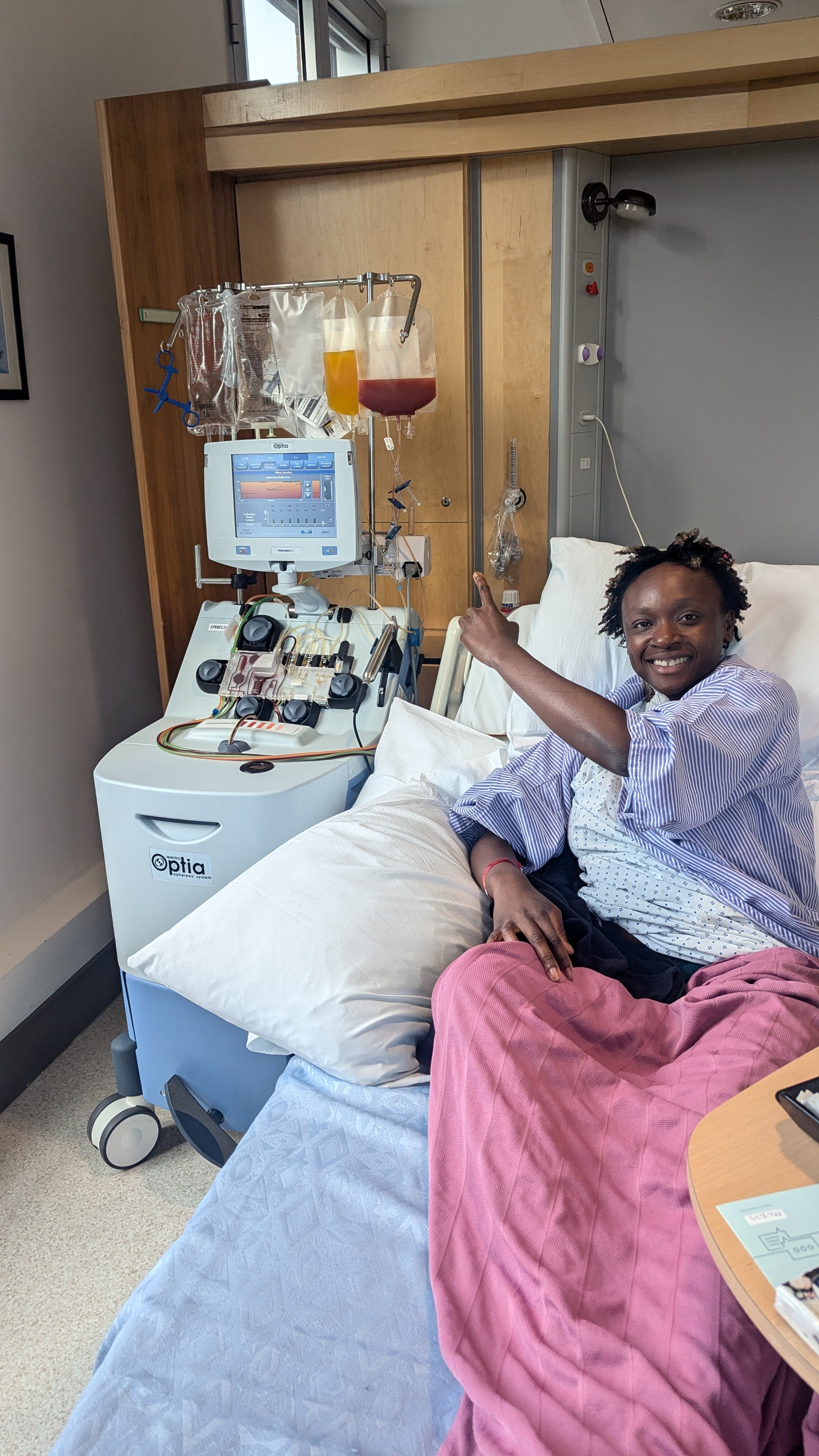 African woman smiling in a hospital bed