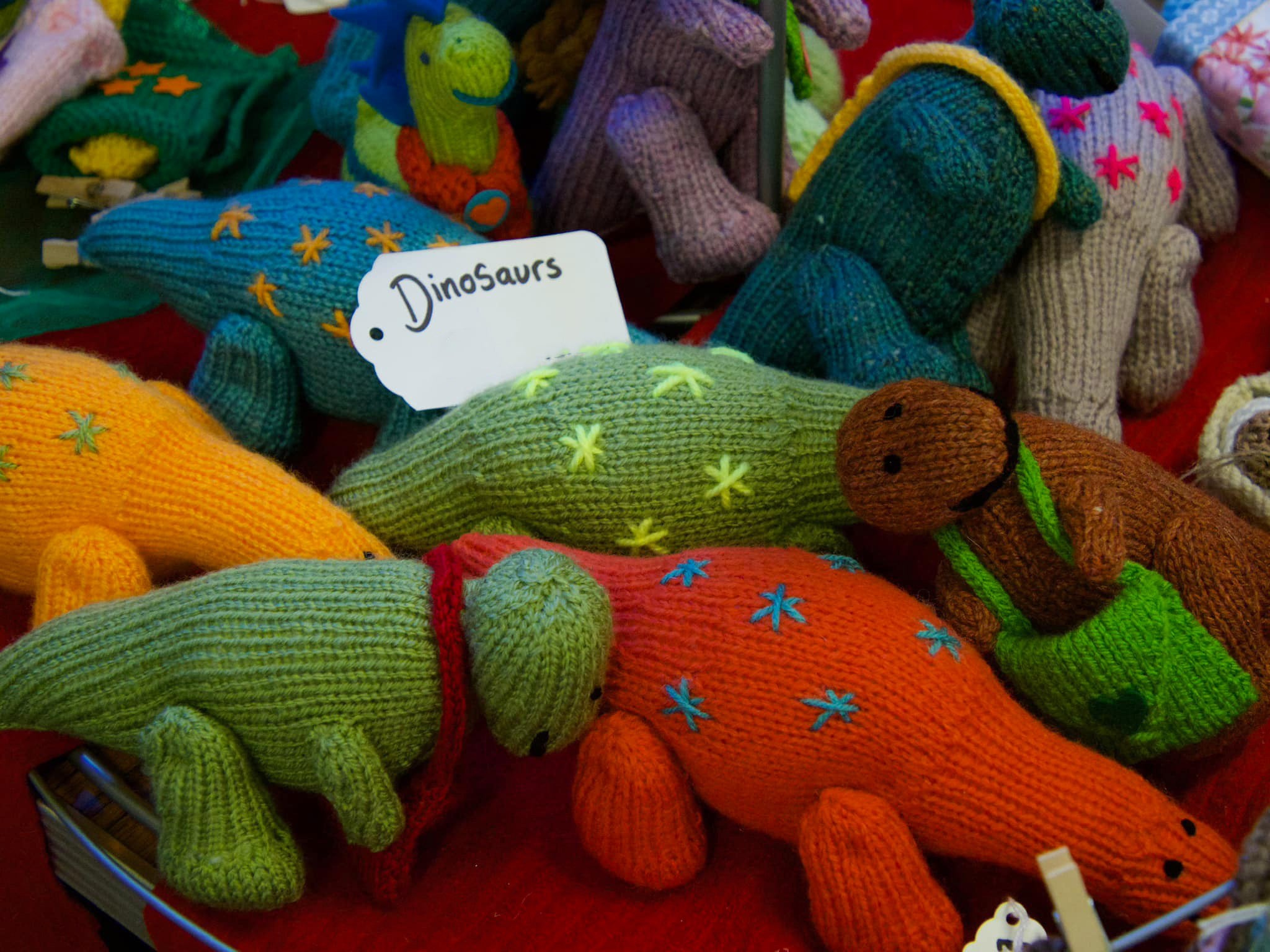 Collection of multicoloured knitted dinosaurs
