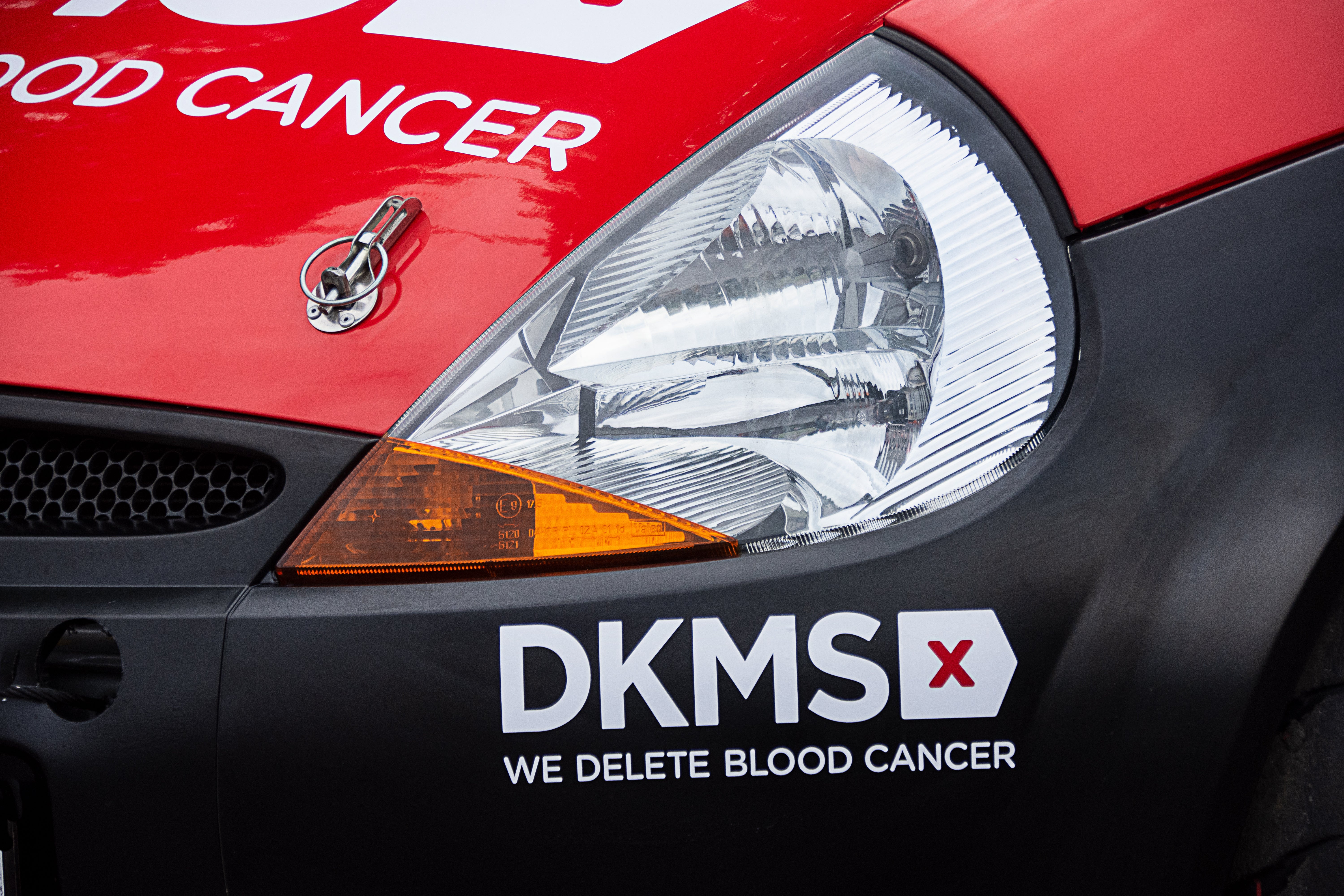 DKMS car showing left headlight and DKMS logo