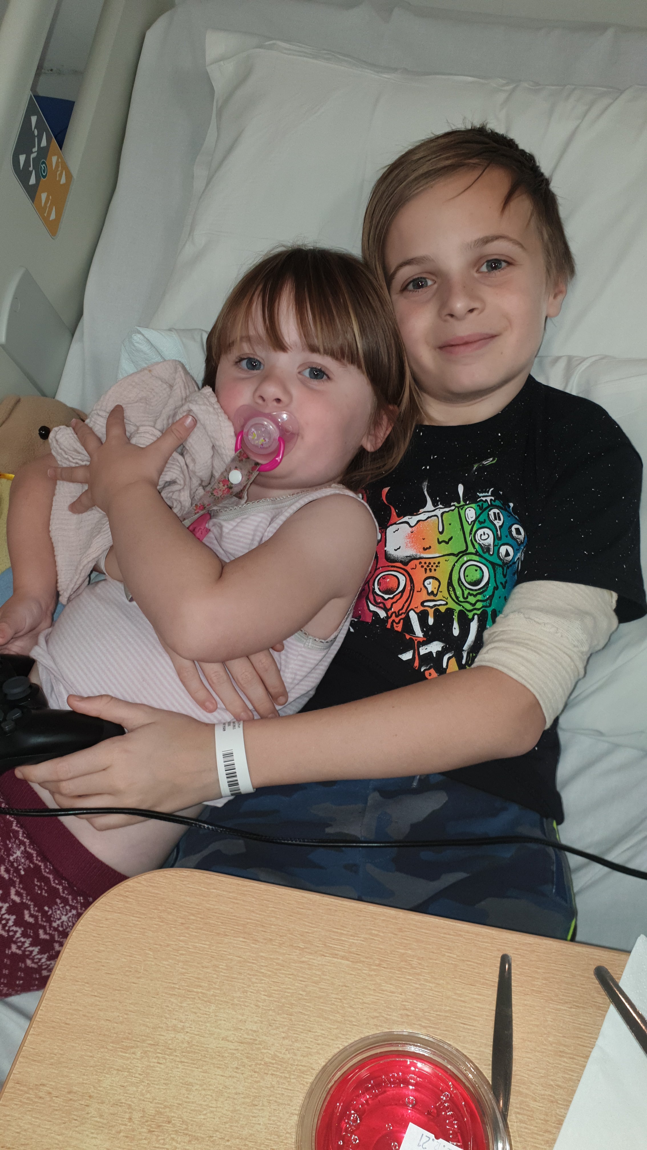 Image of Ethan hugging his sister 