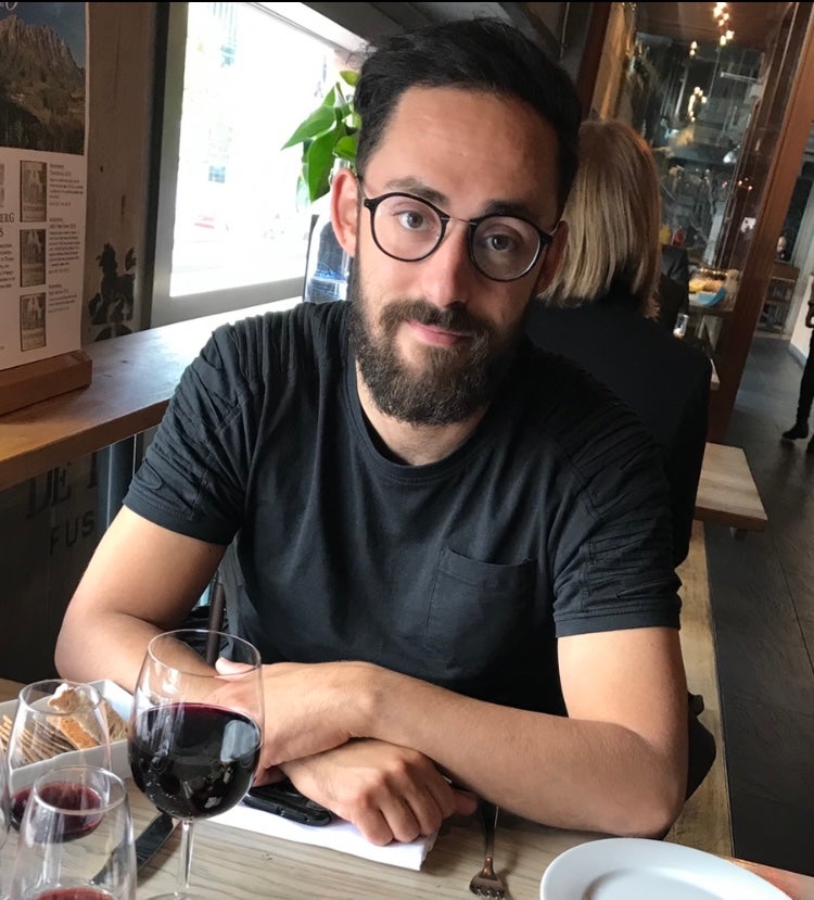 Andy sitting at a table looking into camera.