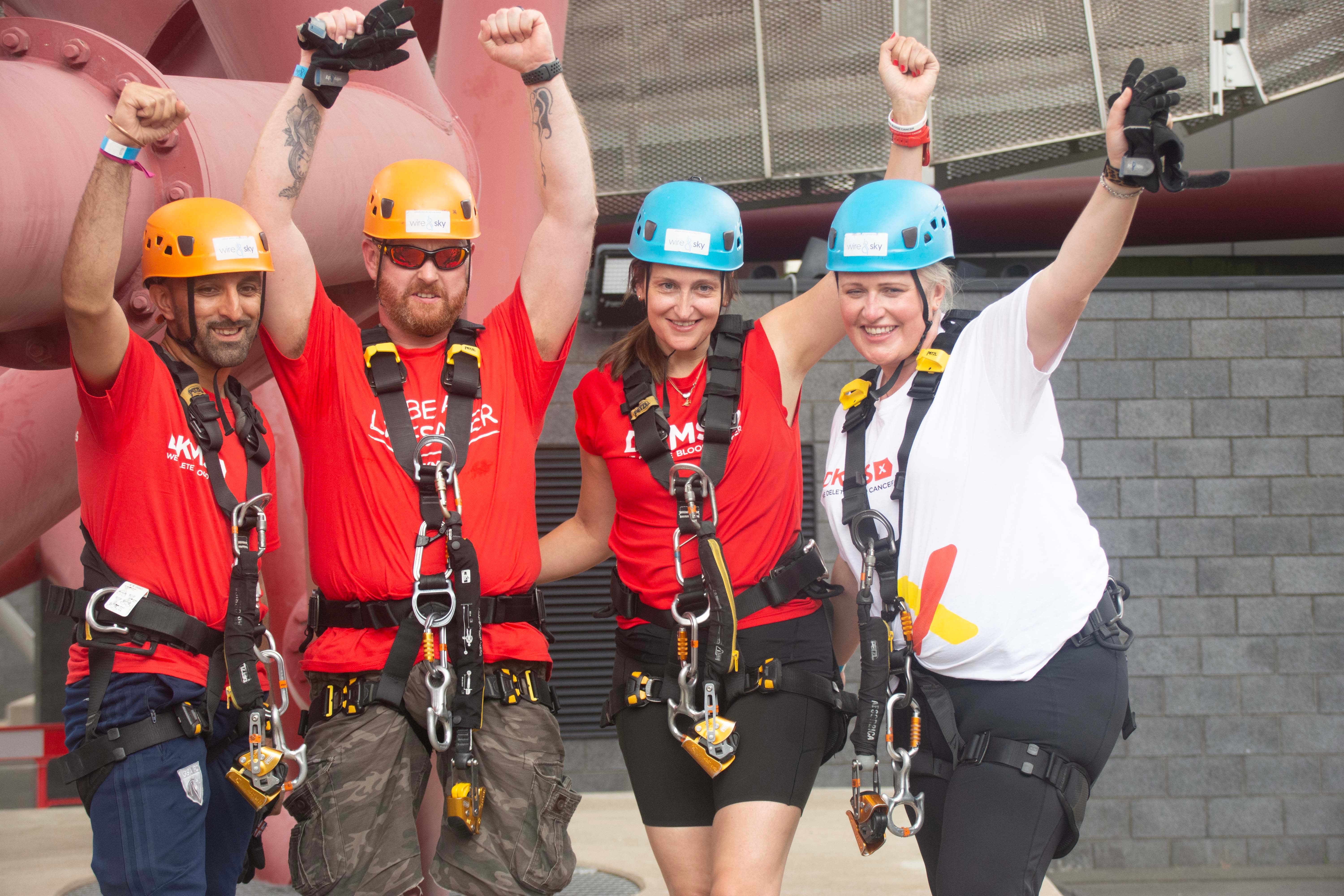 Gilly with Jamie and Fran (DKMS Scotland) and Sam (DKMS West London) in harnesses and helmets preparing to abseil