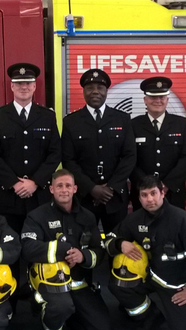 Paul Smith sitting with team mates in their uniform 
