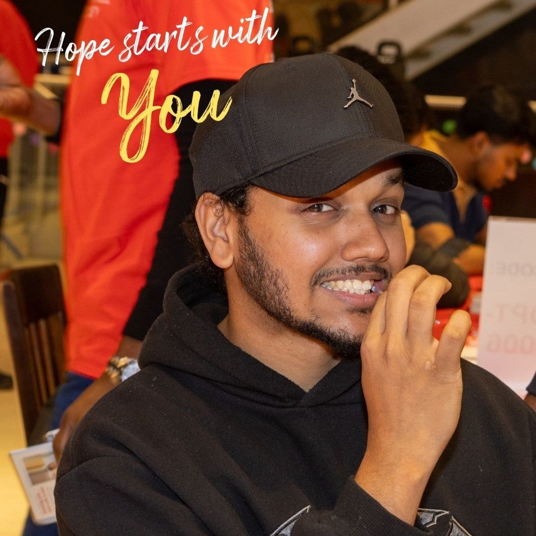 Young man swabbing at a donor drive with the text "Hope starts with you"
