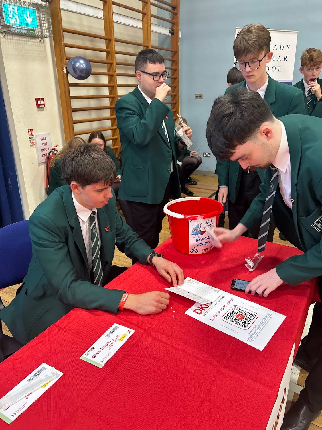 Young boys around a table with their uniform