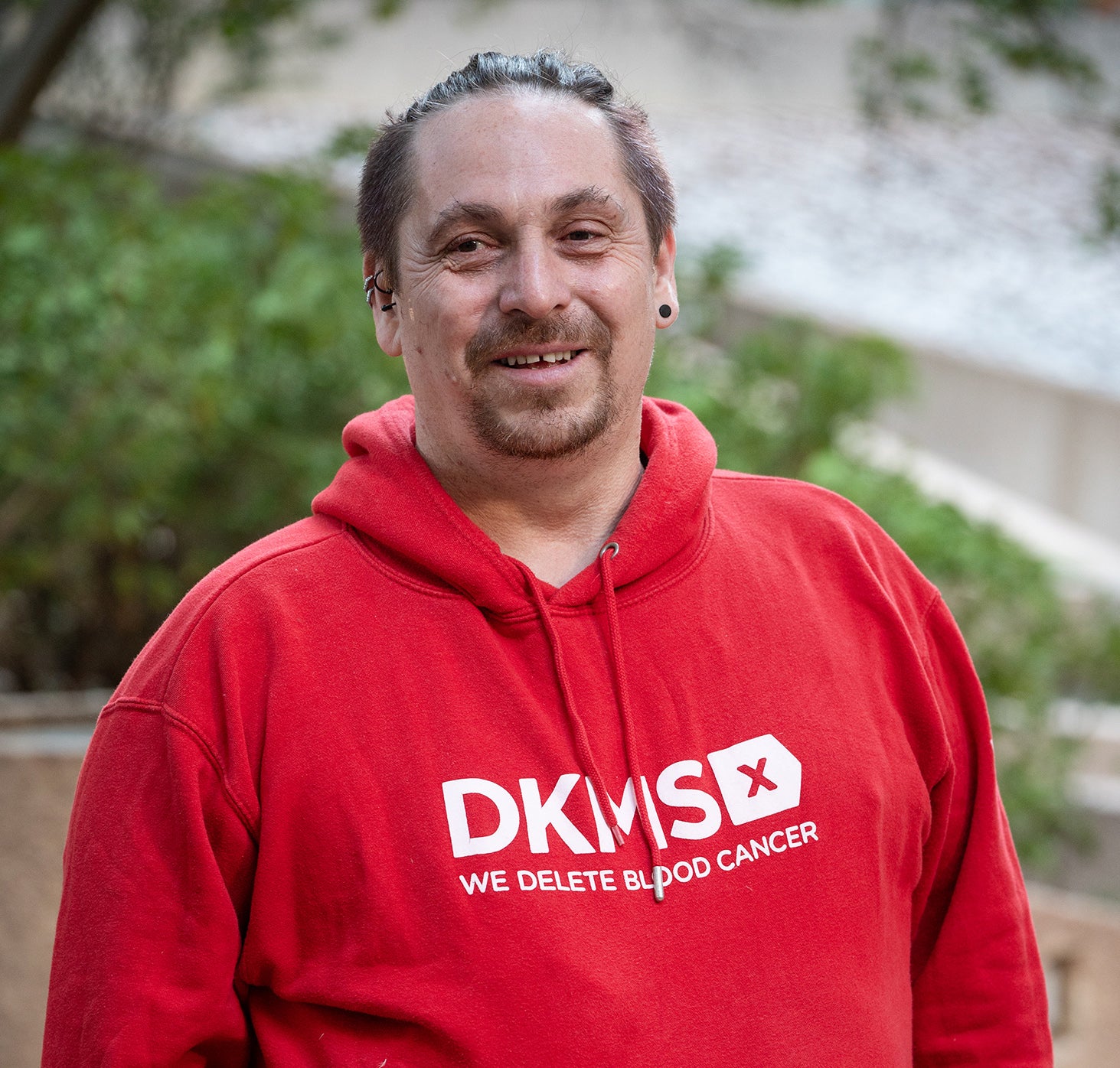 Daniel wearing red DKMS hoodie