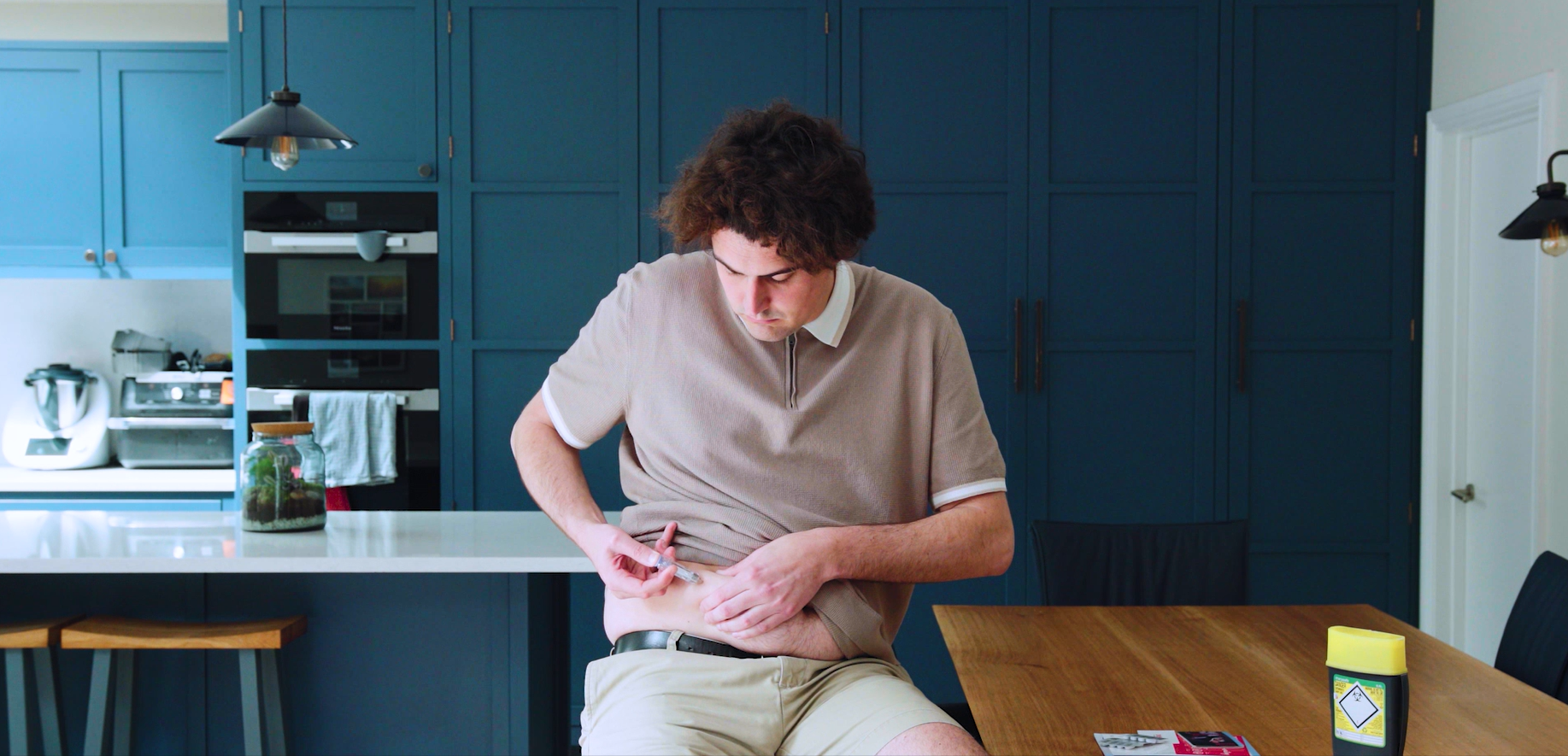 Man injecting himself at home