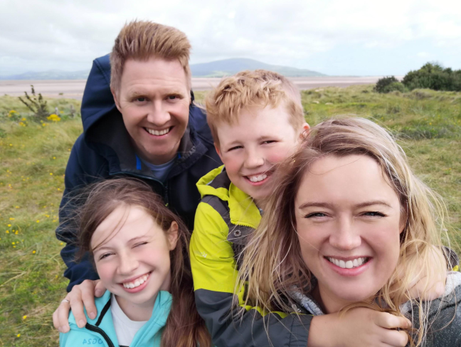 James and his family smiling into the camera. 