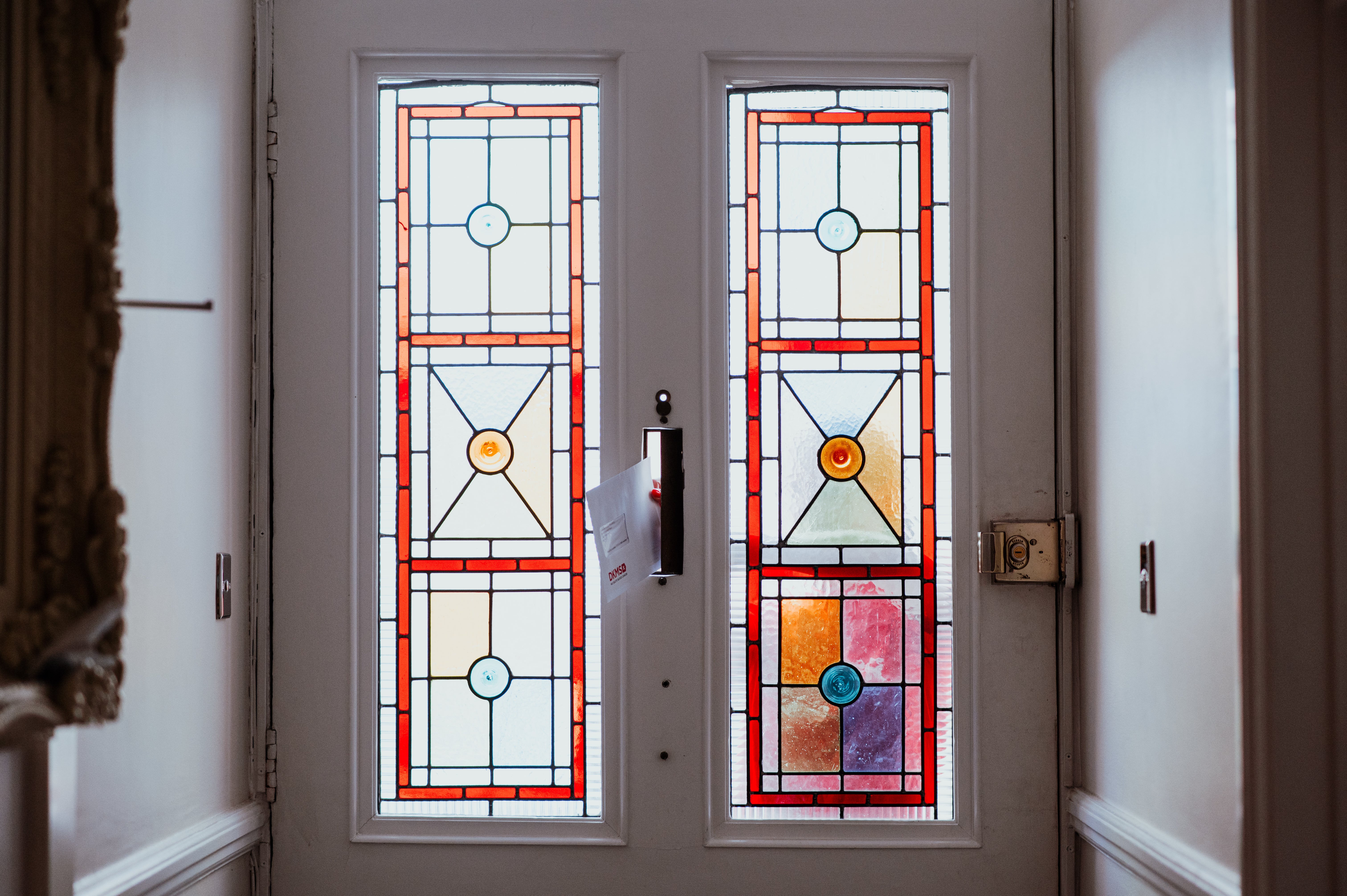 An envelope being posted into a letterbox