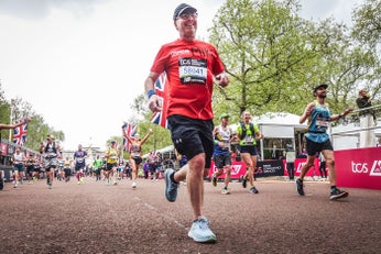 Man in DKMS t-shirt crossing the London Marathon finish line