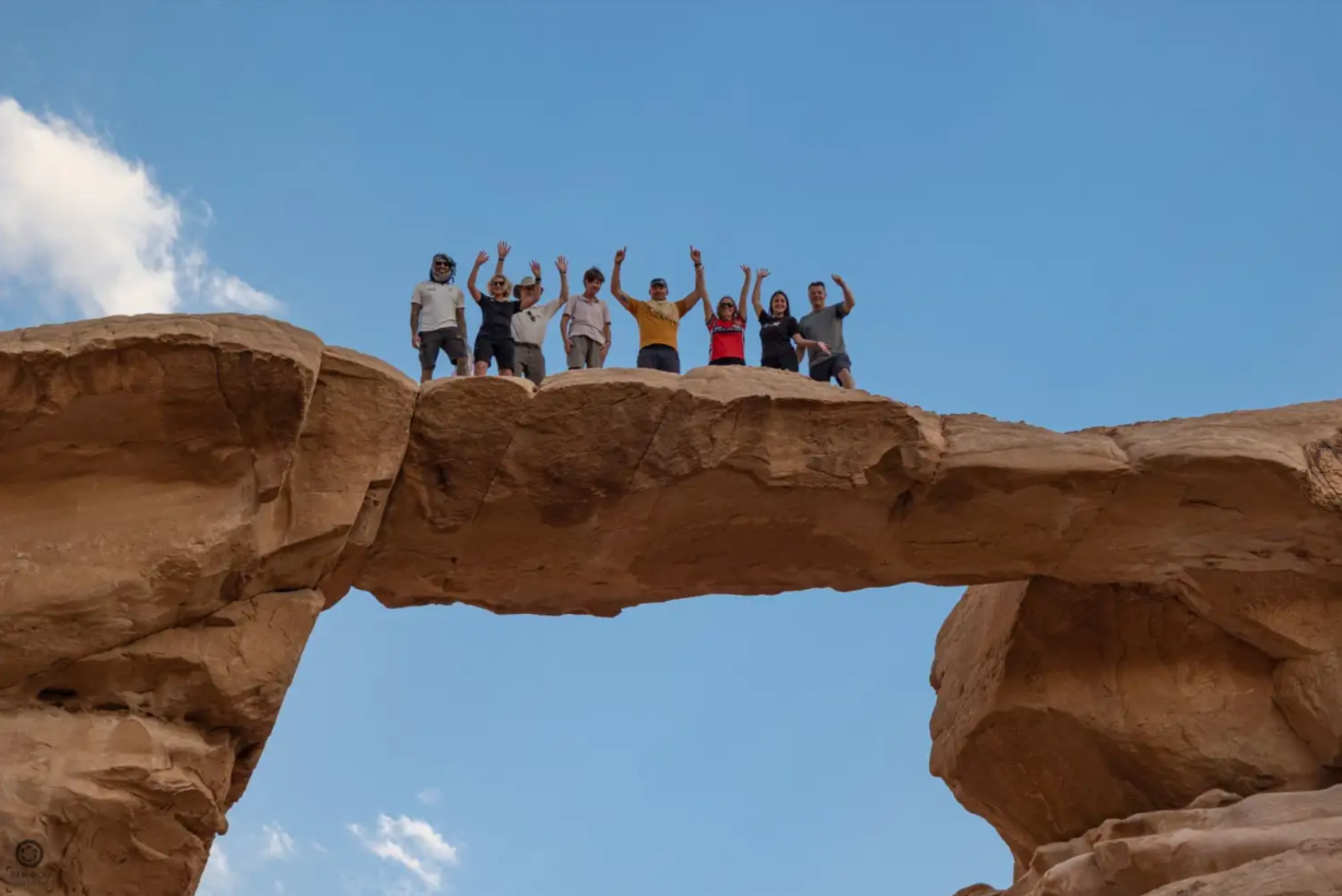 A group walking across a rock formation