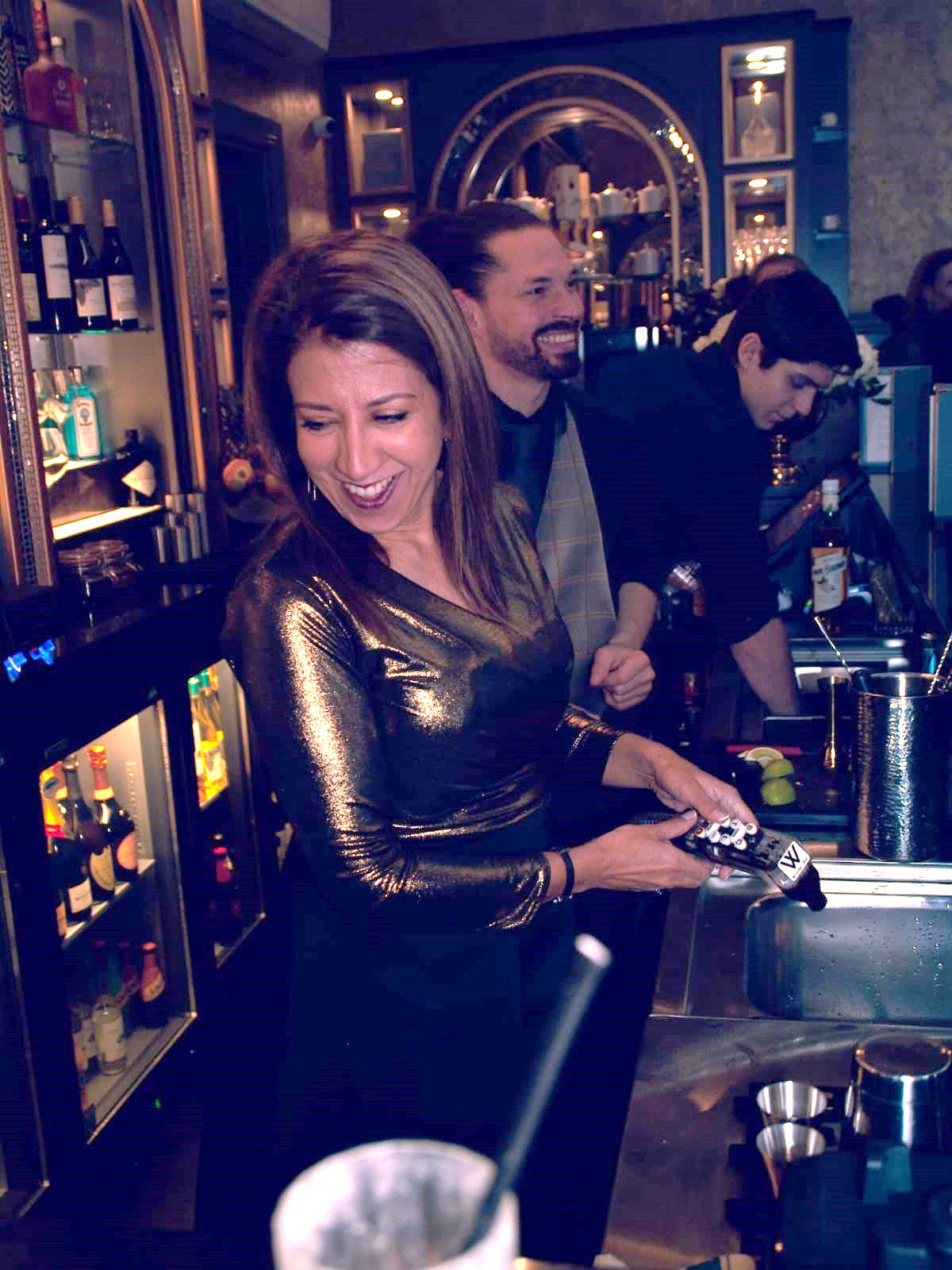 Poonam serving behind the bar at work