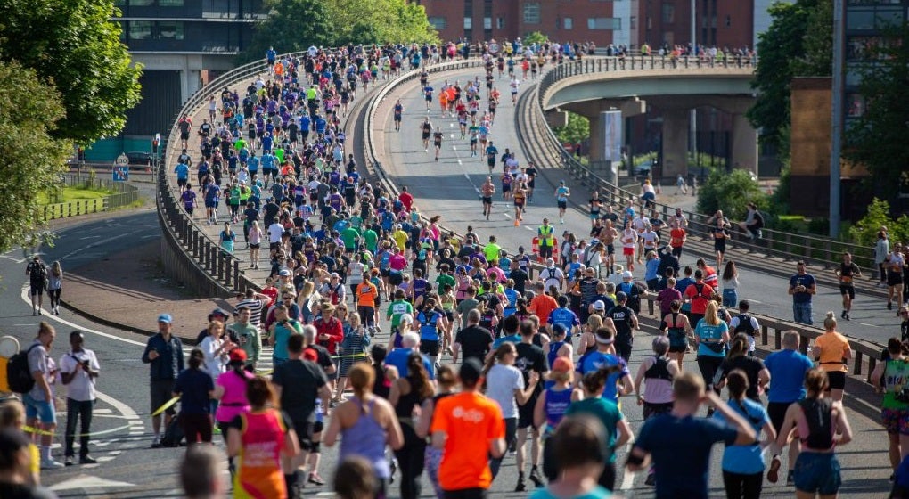 Runners in the Great Manchester Run crossing a bridge
