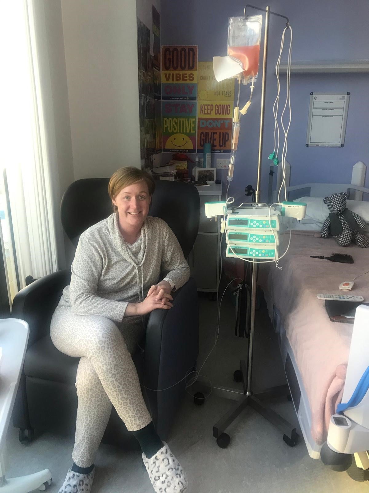 Helen sitting by a hospital bed