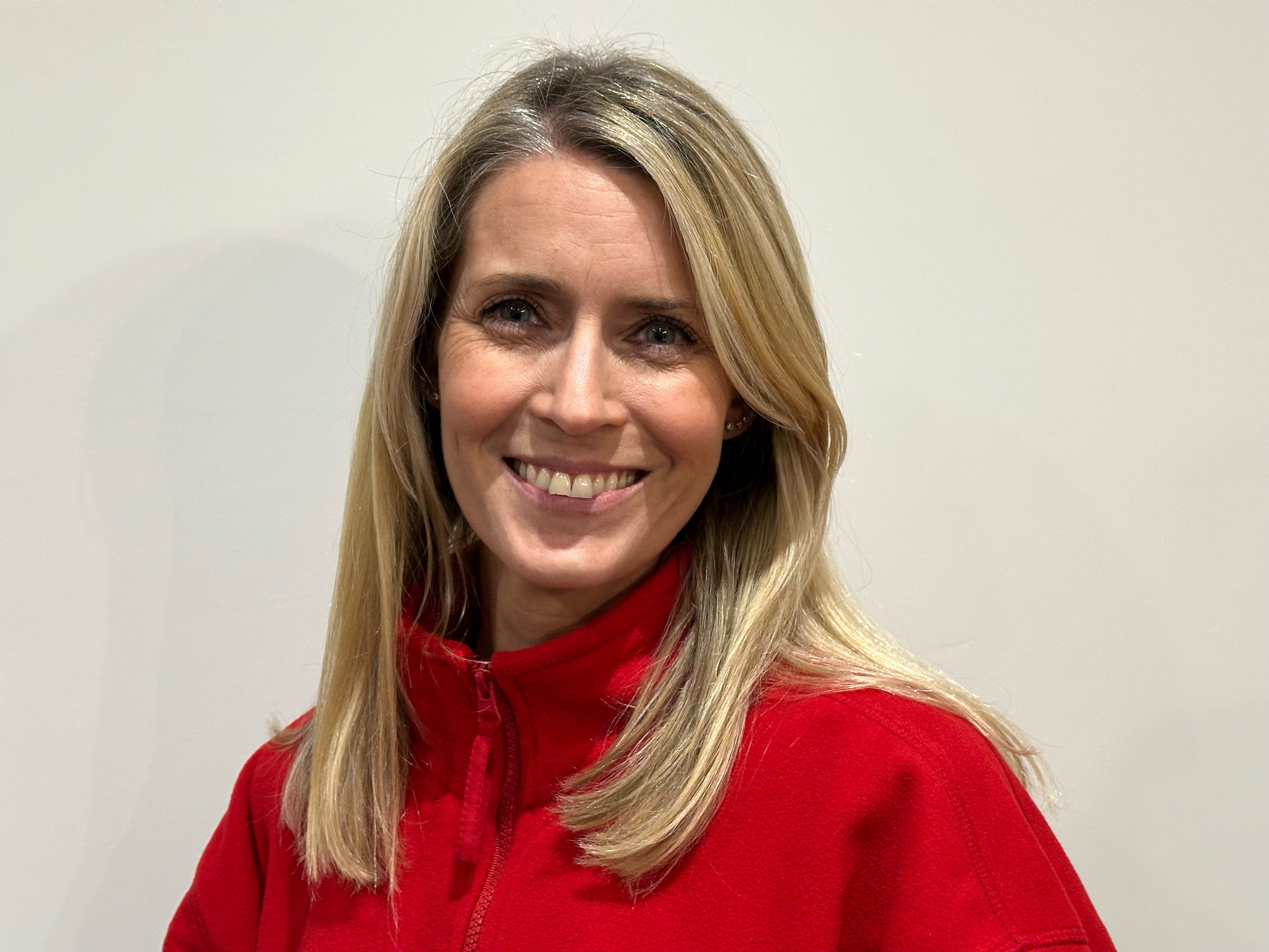 Middle aged white woman in a red sweatshirt