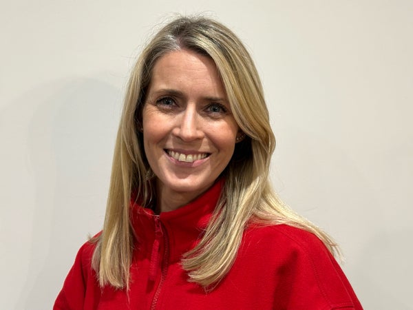 Middle aged white woman in a red sweatshirt