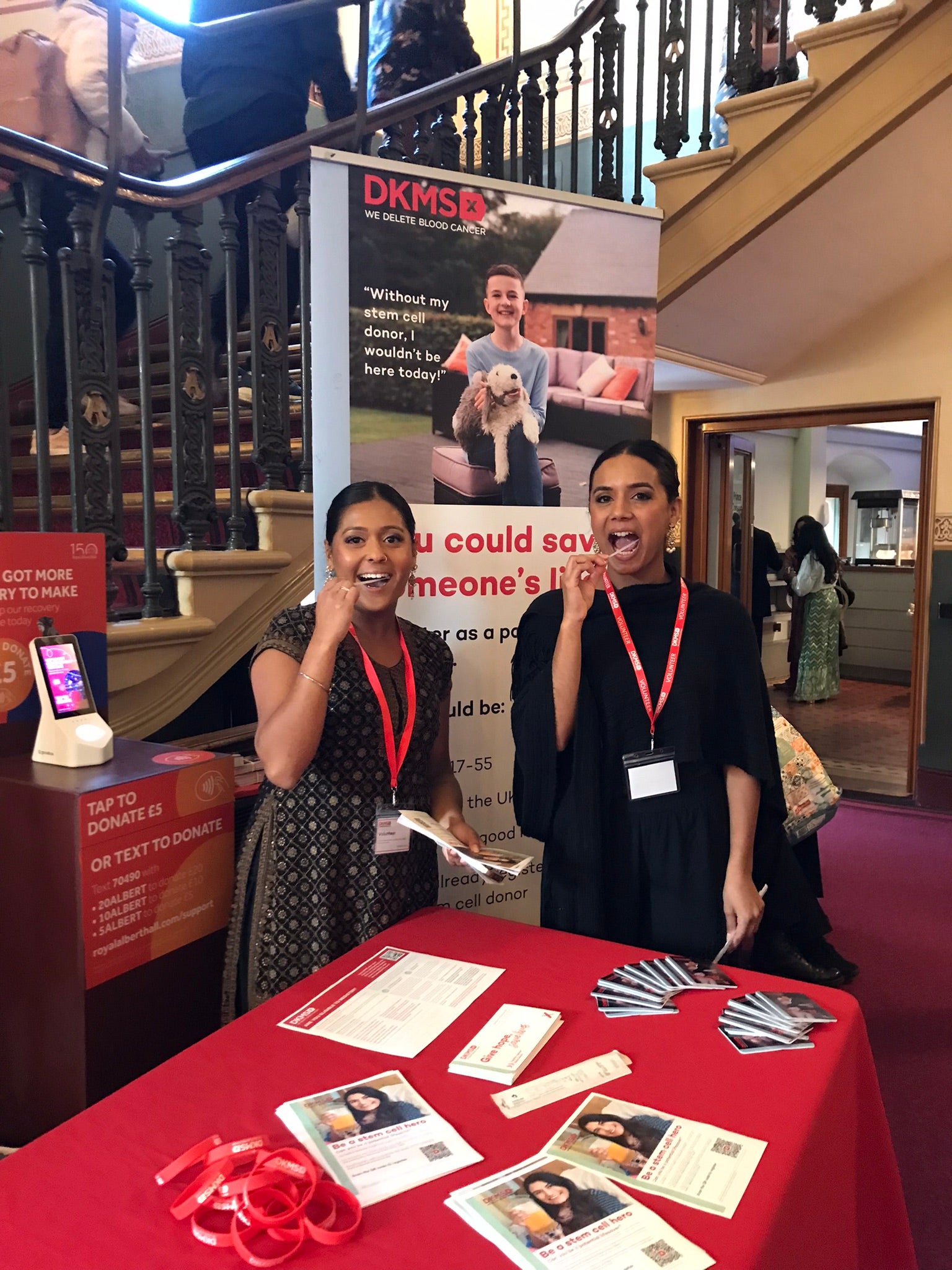 Two Asian women swabbing at a dkms registration event