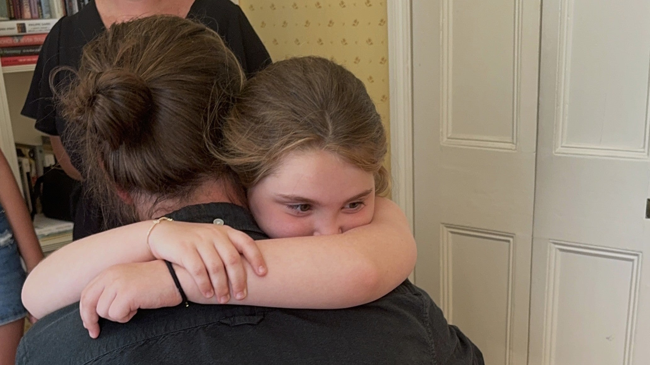 8 year old, Emilia, from the West Midlands hugs Jan, the German man who saved her life with a stem cell transplant