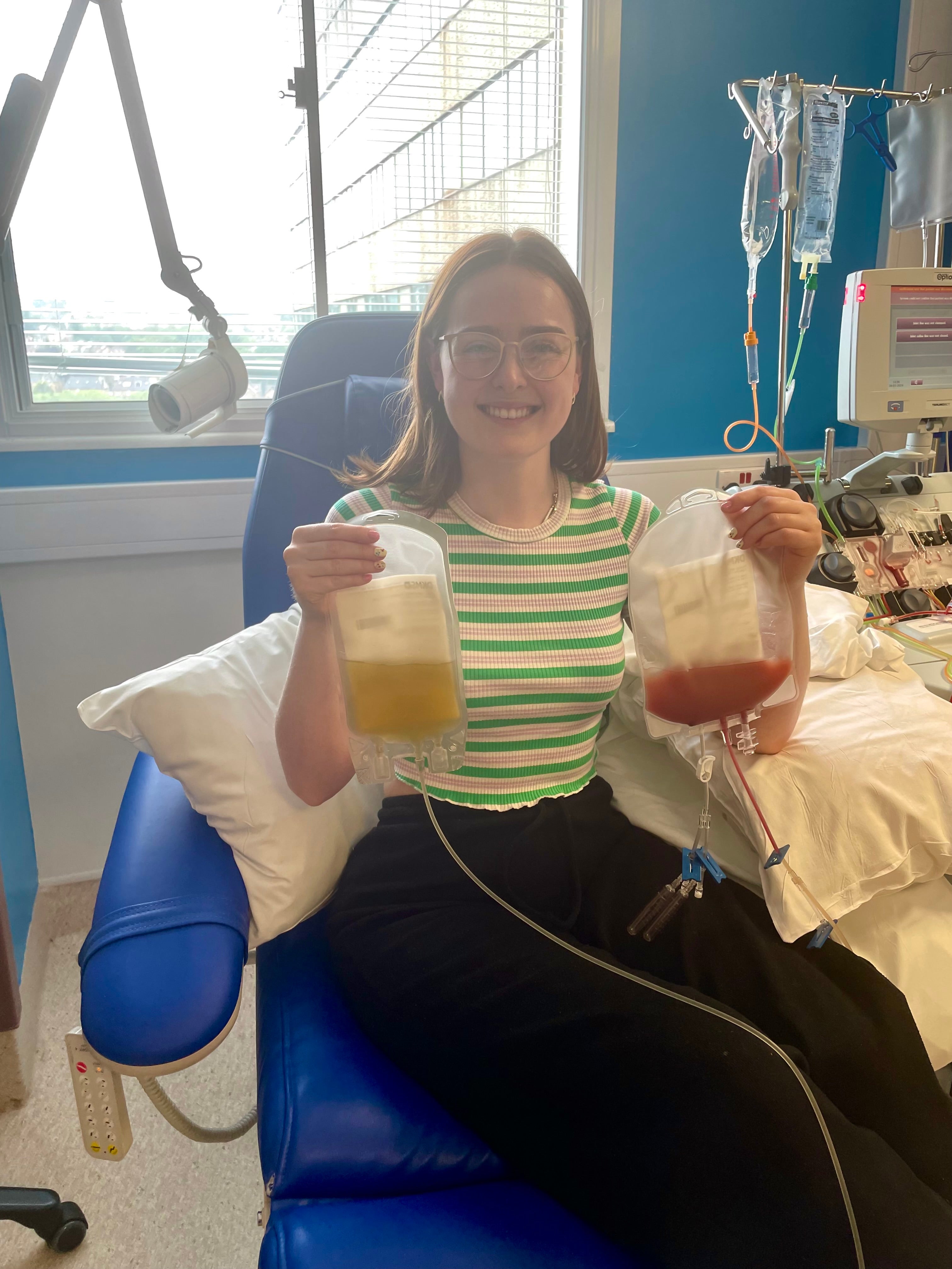 Lady in the hospital holding a bag of stem cells