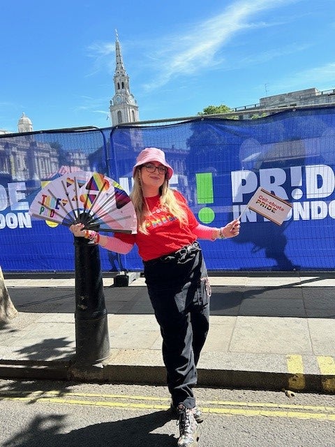 DKMS team member holding up flags at Edinburgh Pride
