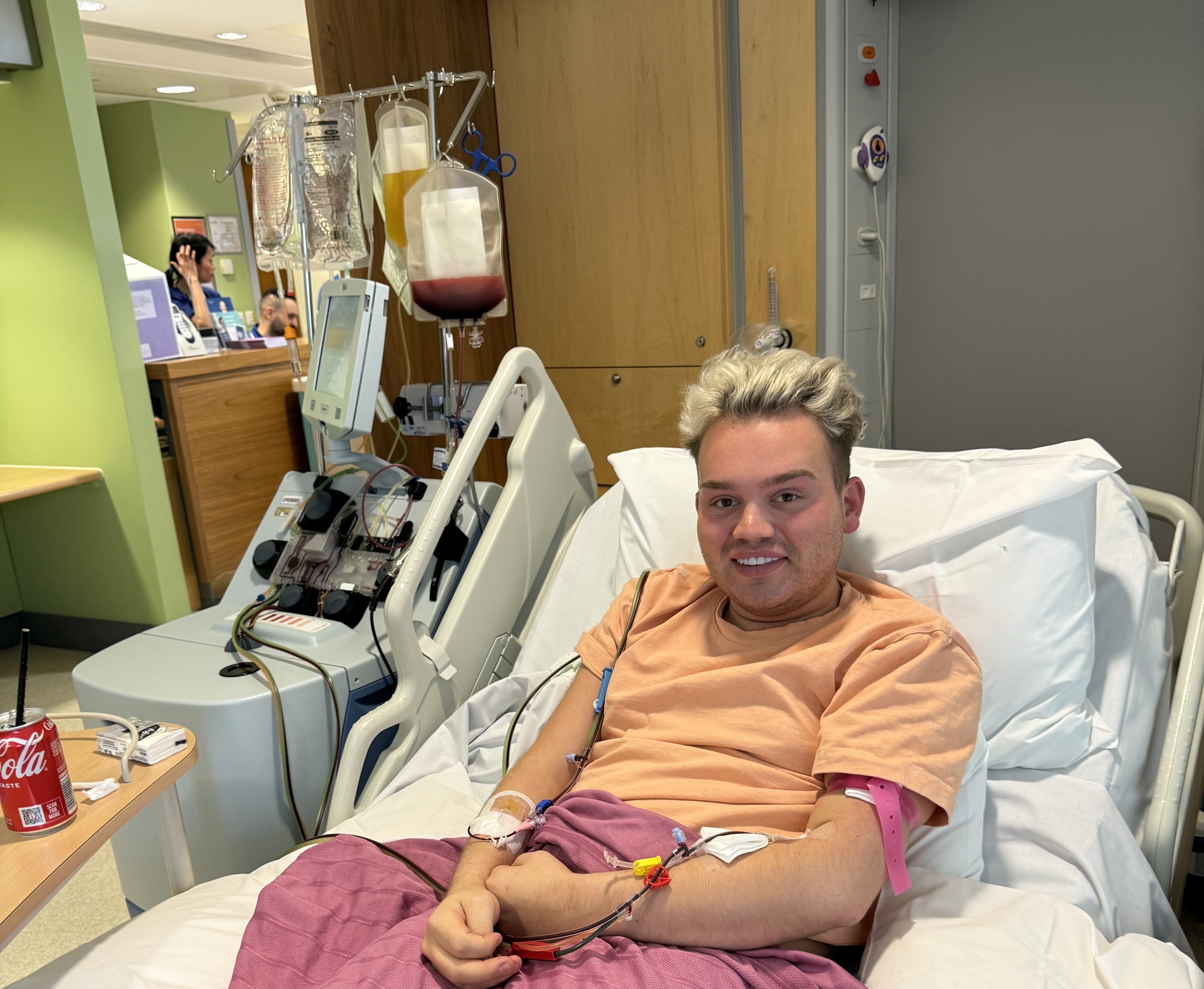Young white man with blond hair smiling on the hospital bed