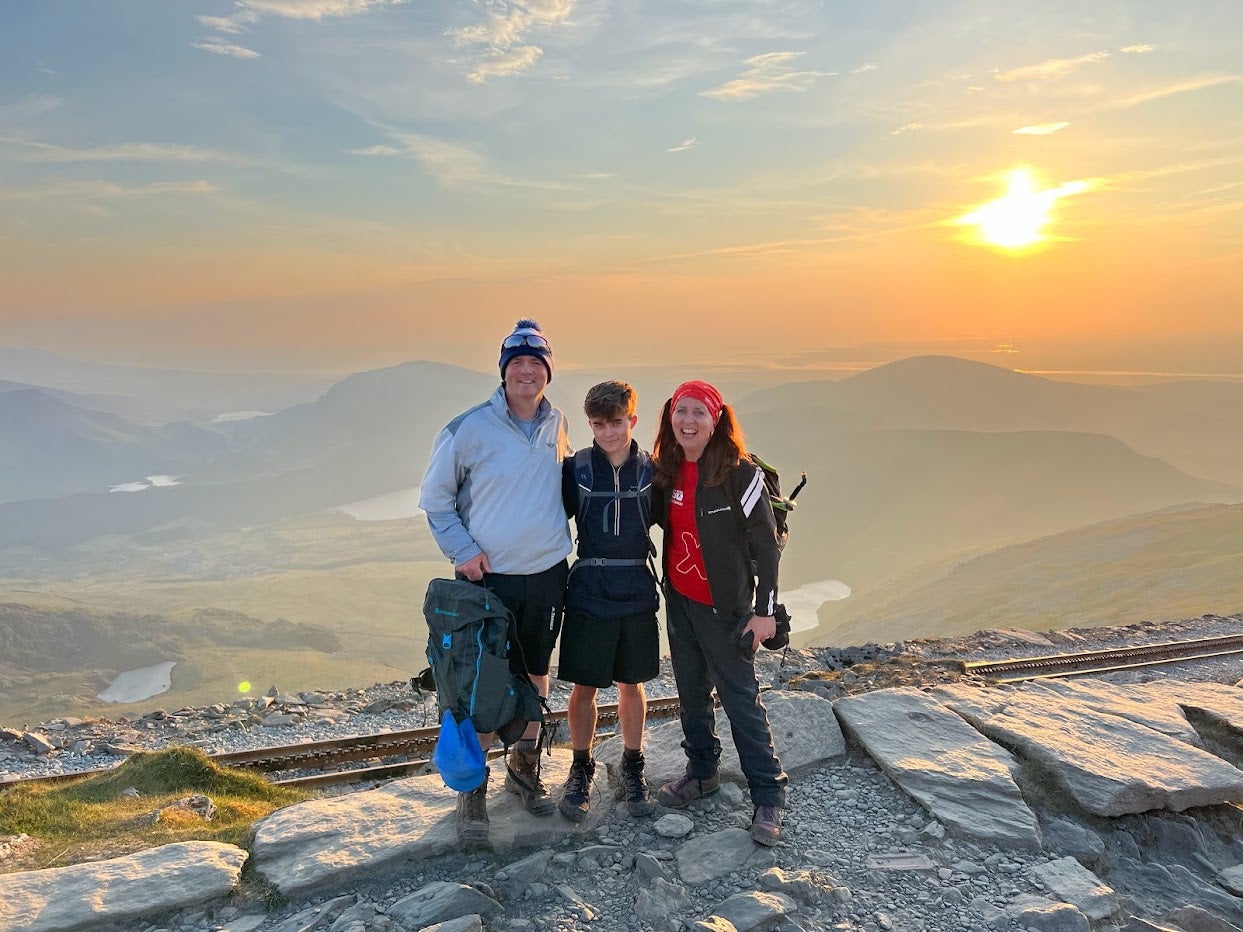 Euan Grant (left and Lou Clague (right) standing on Yr Wyddfam (Snowdon) at sunset