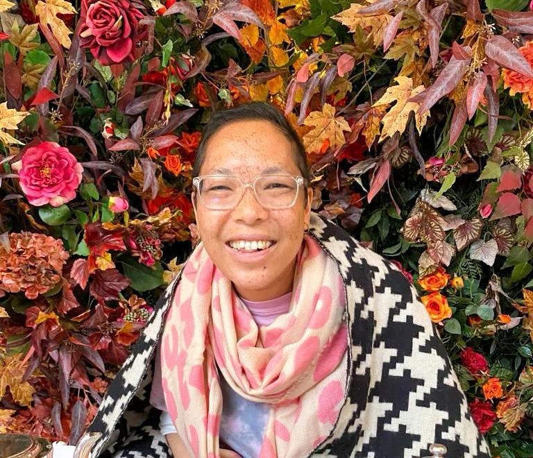 Yvette in a garden, smiling