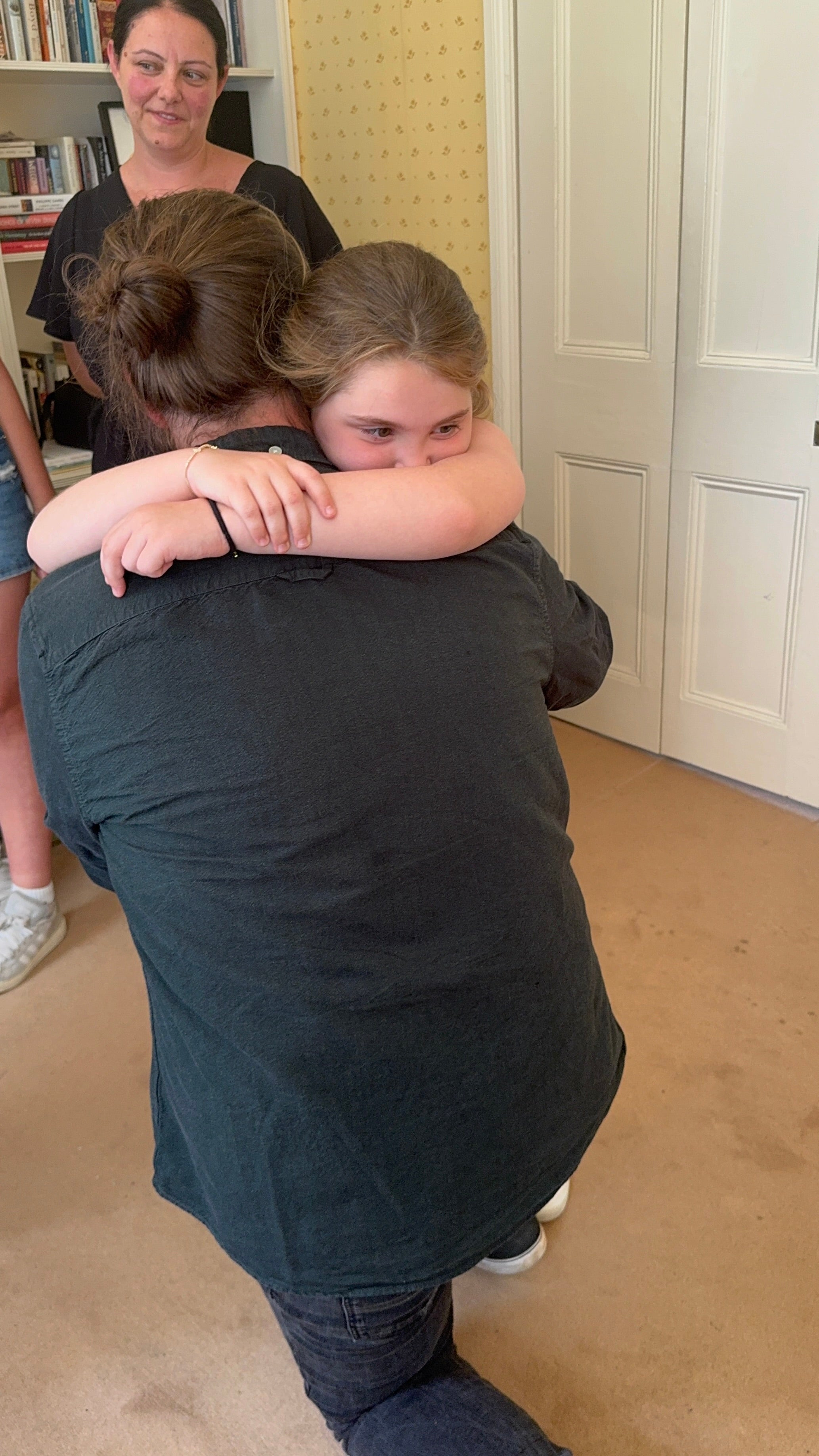 8 year old, Emilia, from the West Midlands hugs Jan, the German man who saved her life with a stem cell transplant
