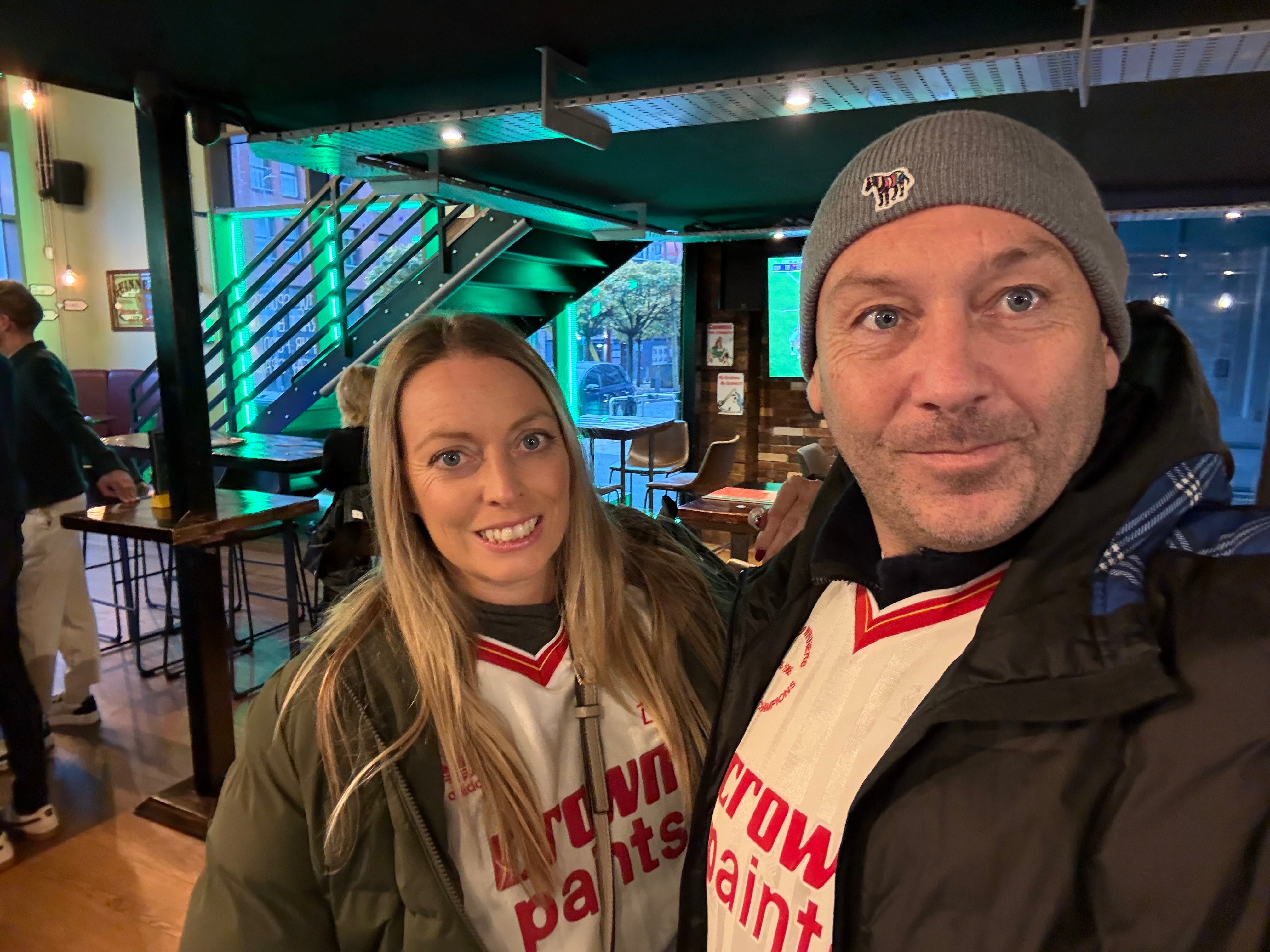 Middle aged white couple in football jerseys