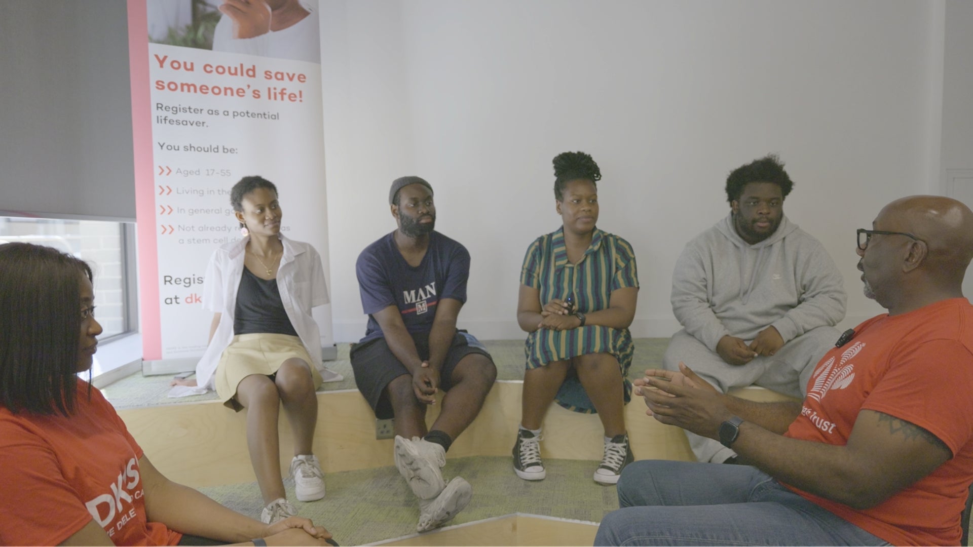 Six African people sitting in a panel style setting