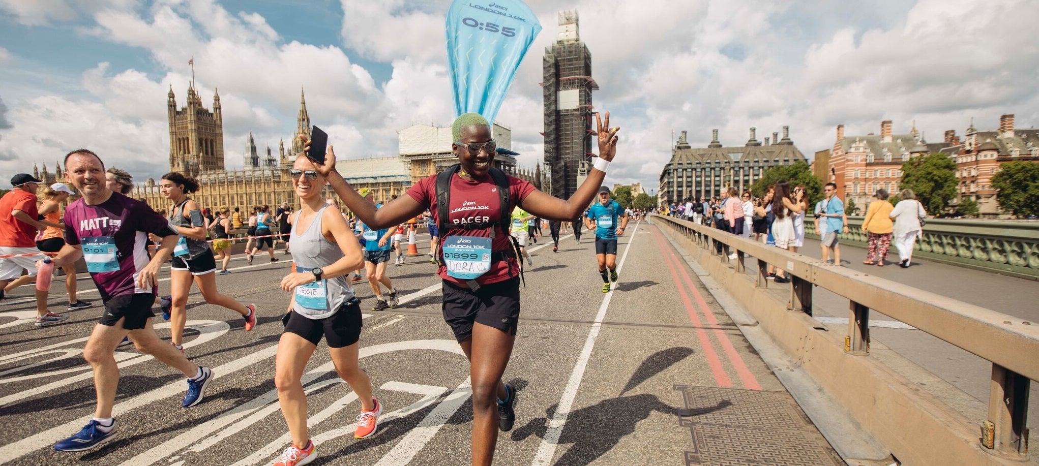 Several people running across London Bridge