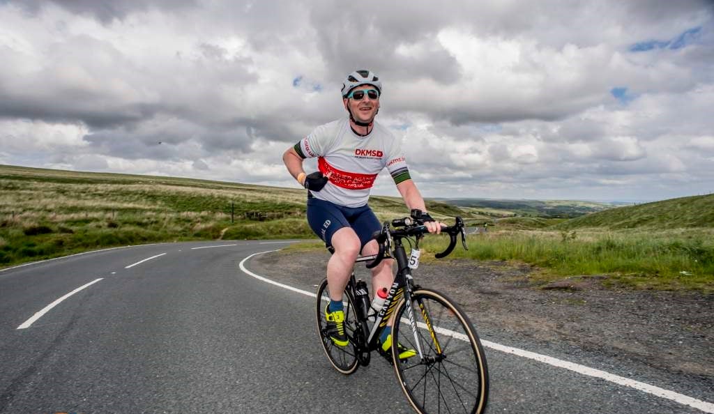 Image of man cycling in a DKMS top