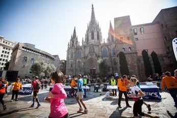 Runners in race in Barcelona, passing by historic buildings