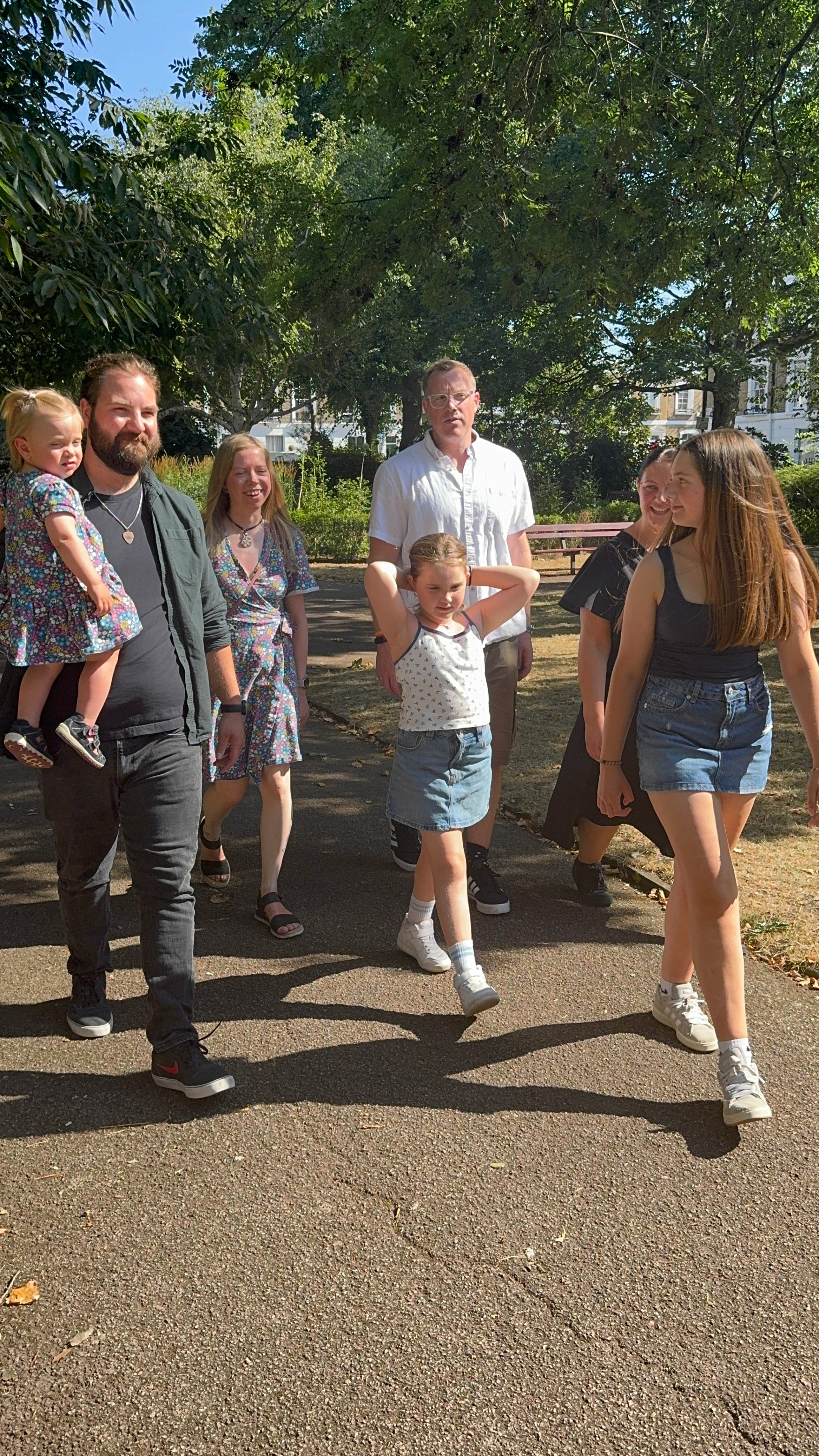 Patient Emilia and Donor Jan's families walk together through the park in London after they meeting for the first time after Jan saved Emilia's life through a stem cell donation