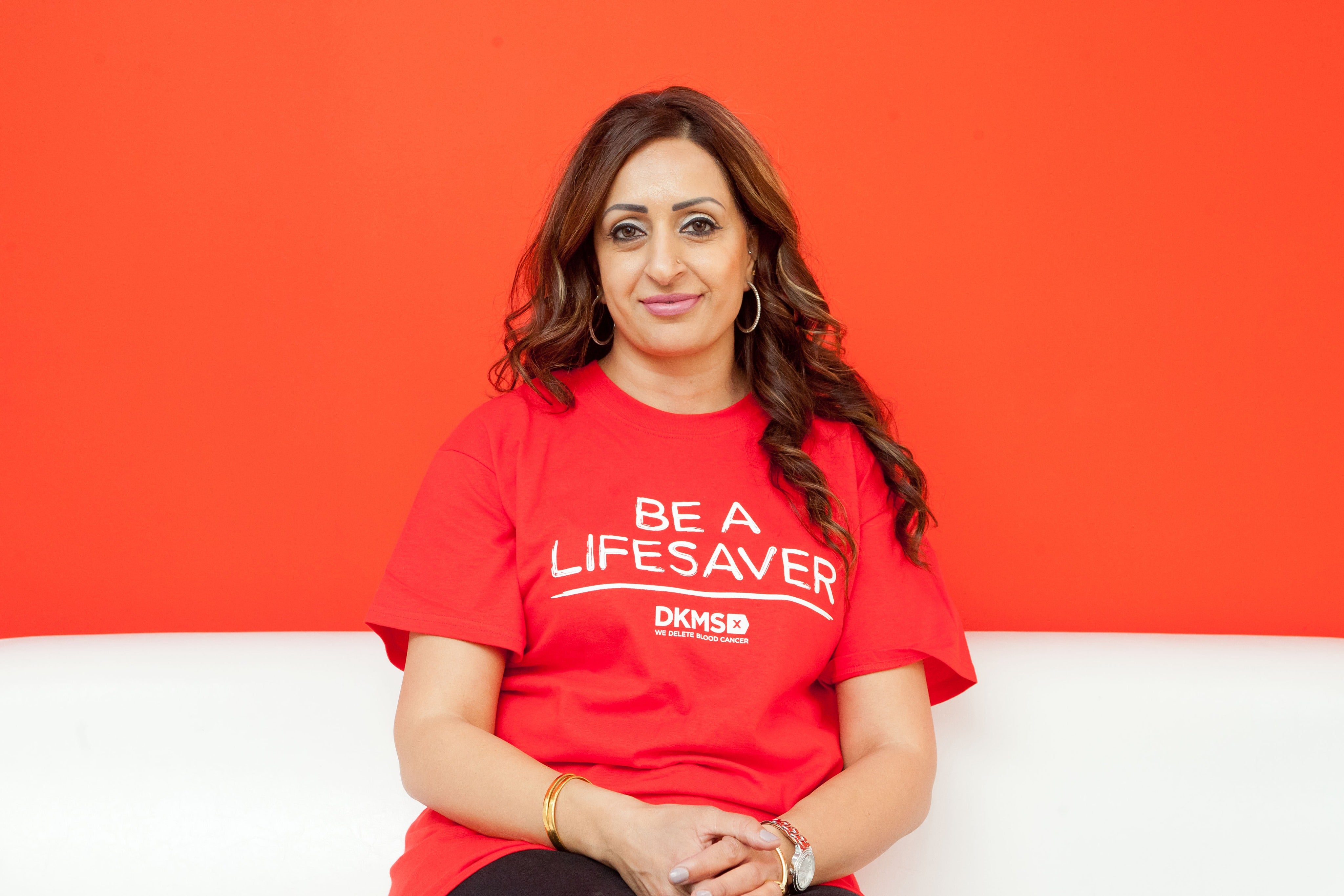 Person wearing a DKMS T-shirt sitting down