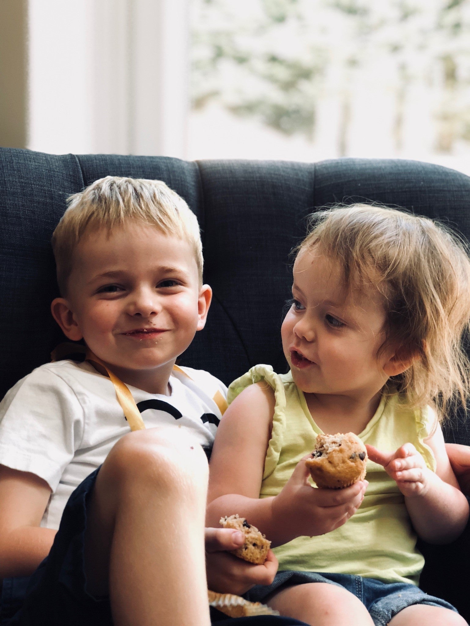 Henry and Alice eating cake and smiling at the camera. 