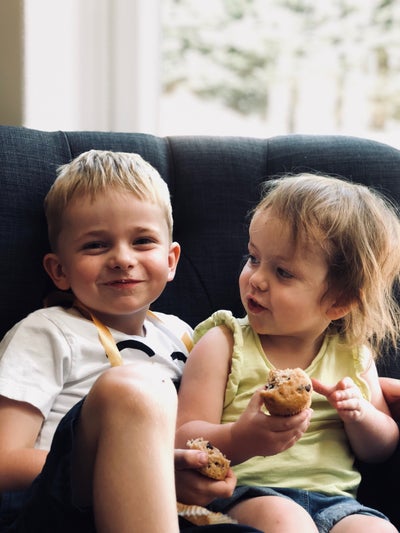 Henry and Alice eating cake and smiling at the camera. 