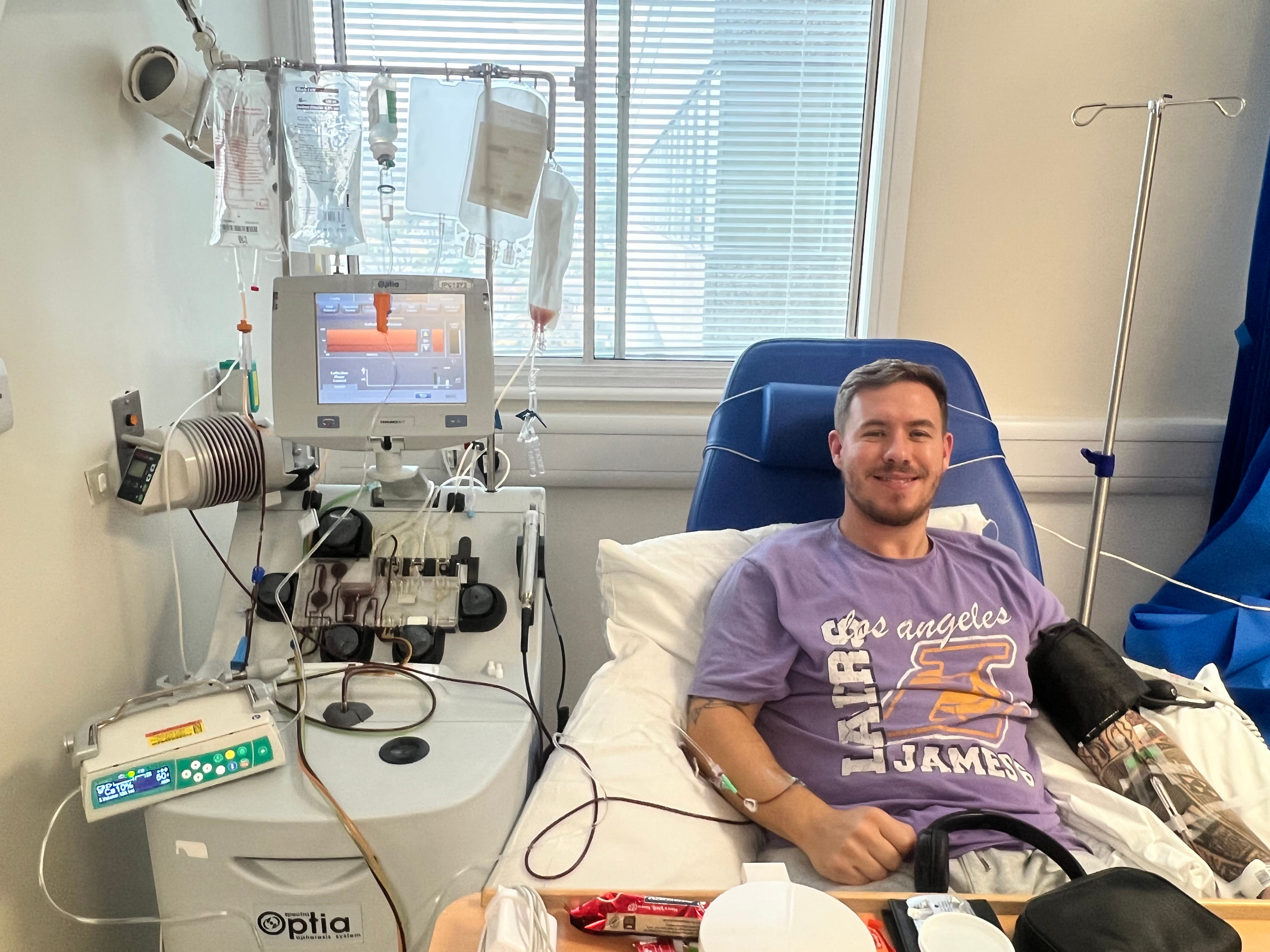 Ashley lying on hospital bed giving his donation