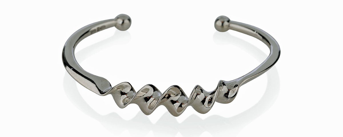 A silver ribbon bangle form the Torc Collection