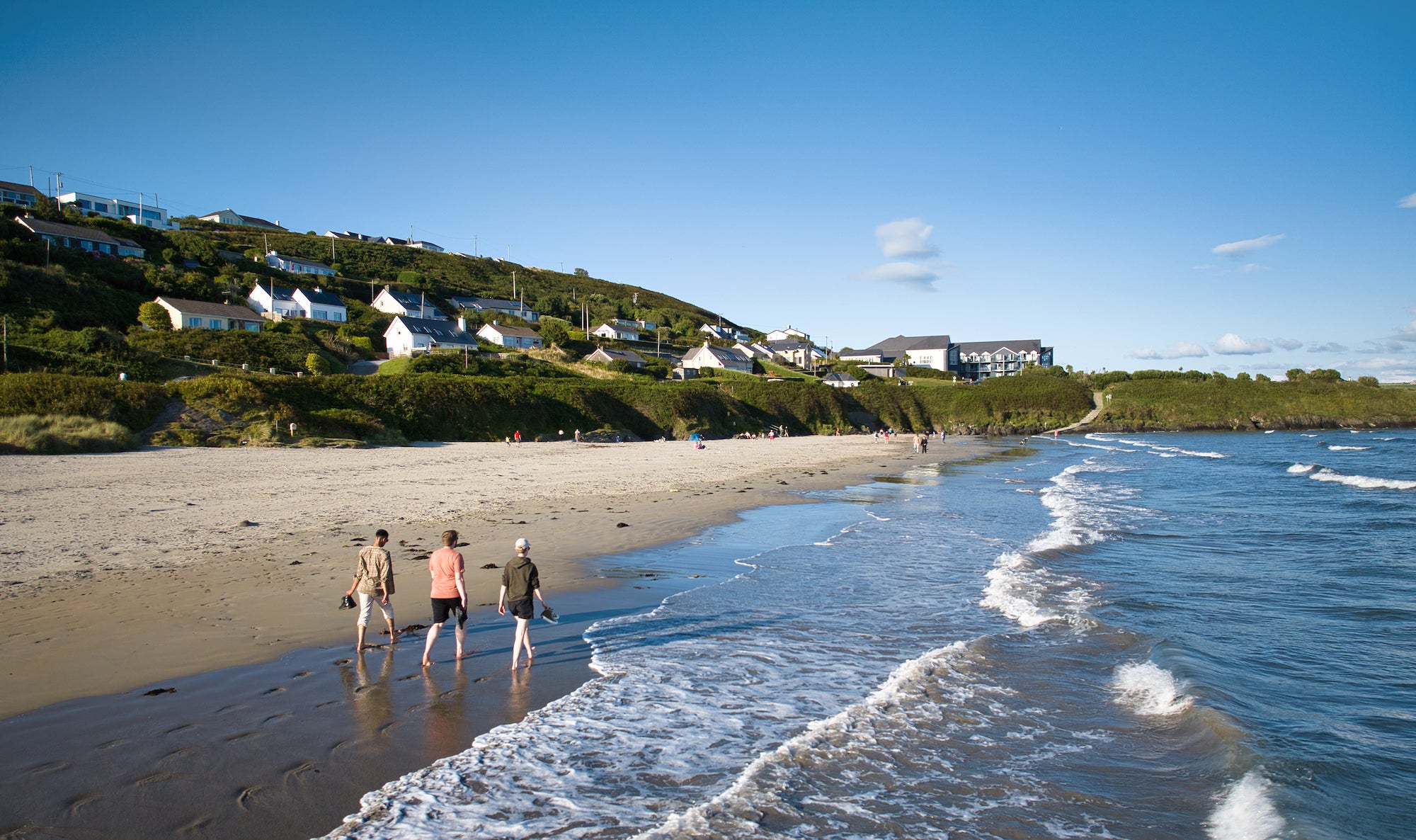 People walking on Inchydoney Beach in Clonakilty, Co Cork
