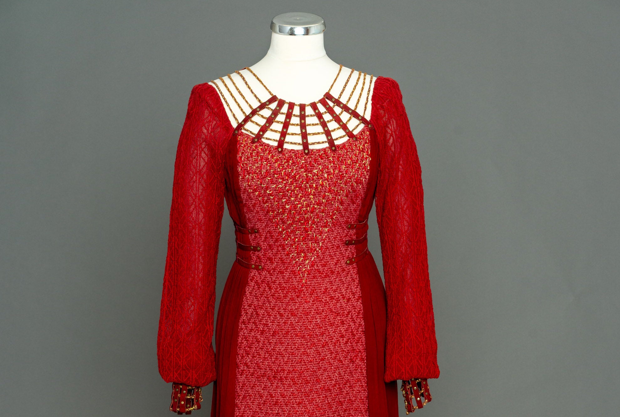 Vikings TV series - Katheryn Winnick as Lagertha. Top view of long, fitted red dress on a mannequin.