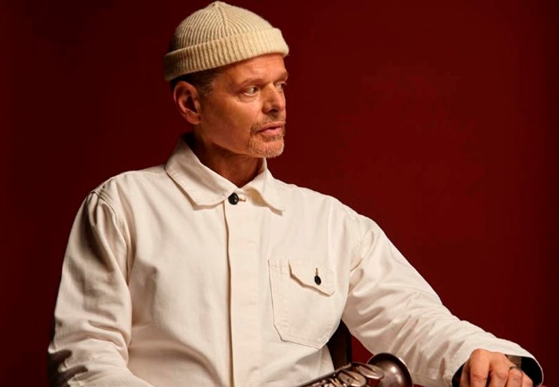 A man seated at a table looking away to his left