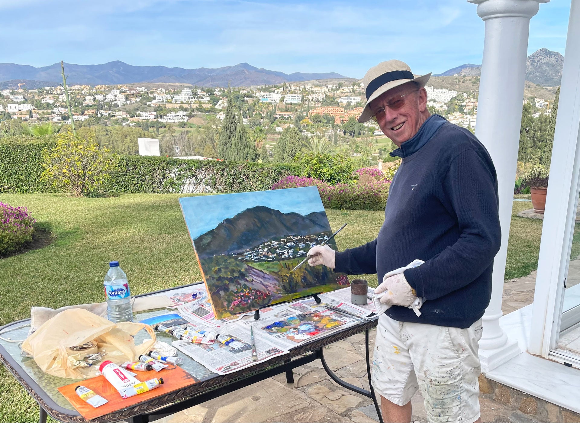 Michael Hanrahan Art view of the artist painting a landscape with mountains