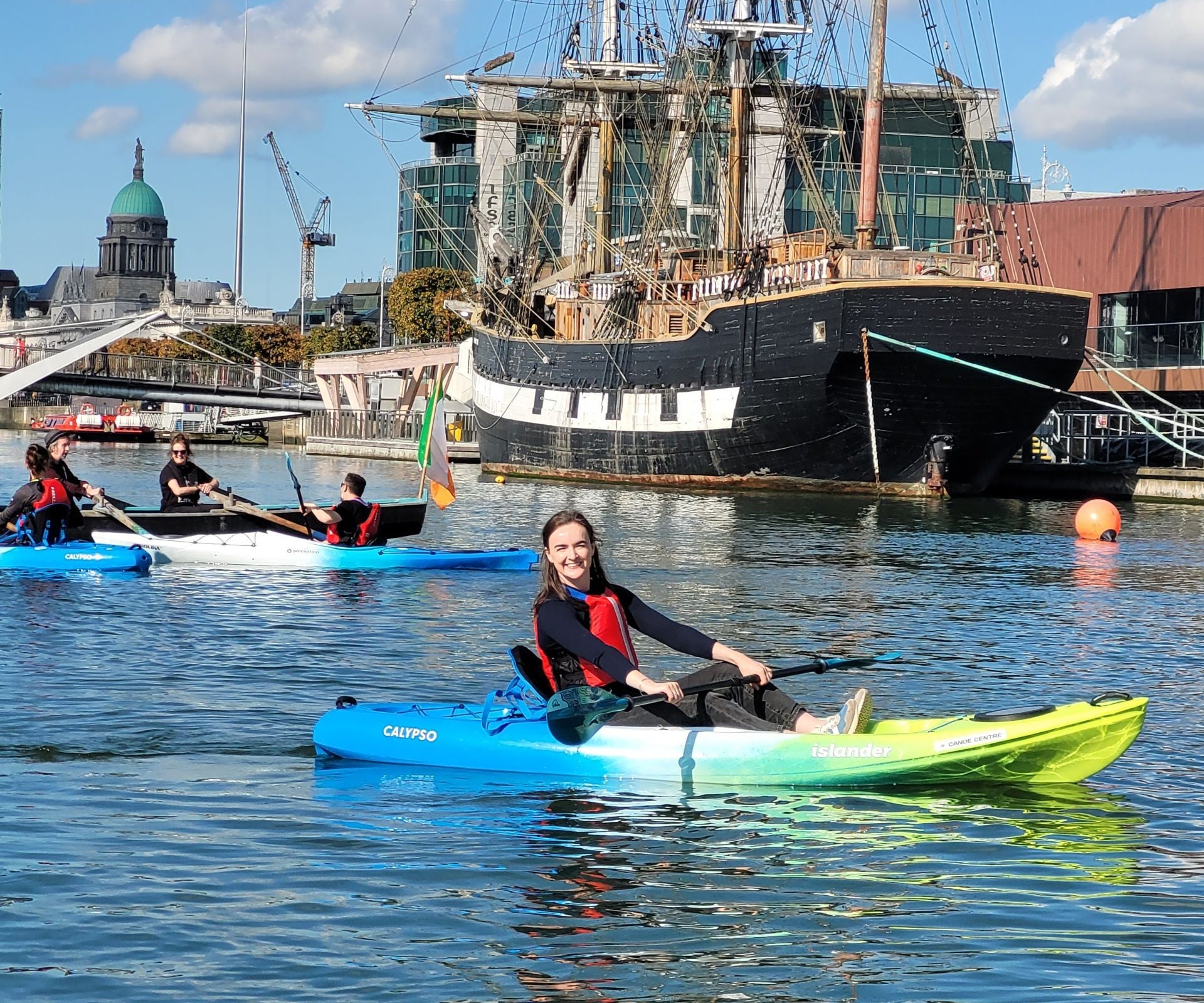 A group out kayaking on the River Liffey with the Jeannie Johnson famine ship in the background