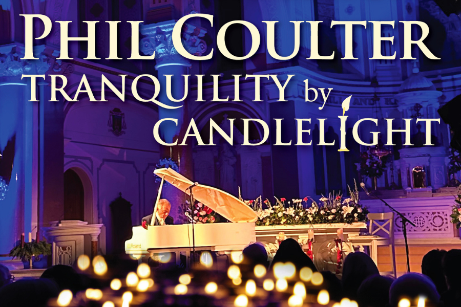 Phil Coulter - Tranquillity By Candlelight, a man seated at a pale grand piano with blurry lit candles in the foreground
