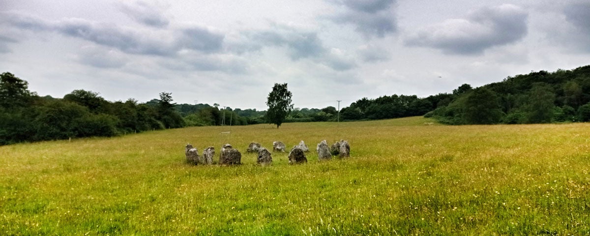 A small standing stone circle in a green meadow at Celtic Park