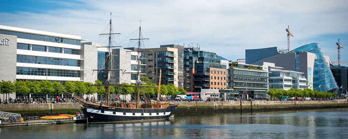 A view of the Jeanie Johnston docked on the Custom House Quay in Dublin's Docklands with a view of the Convention Centre in the background